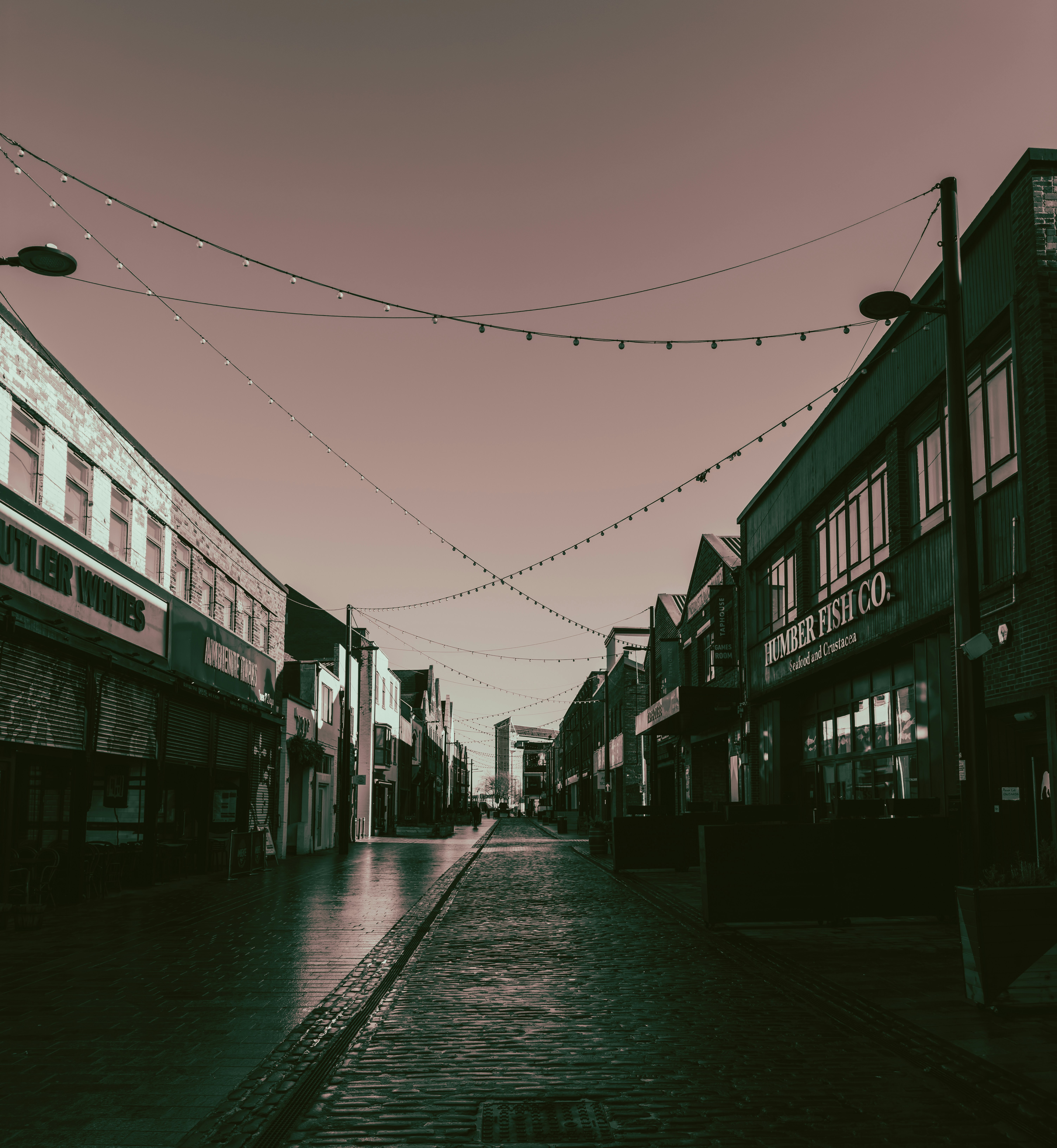 A street lined with buildings and lights.