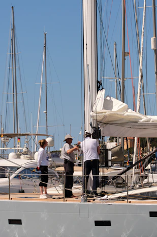 People working on the mast of a sailboat