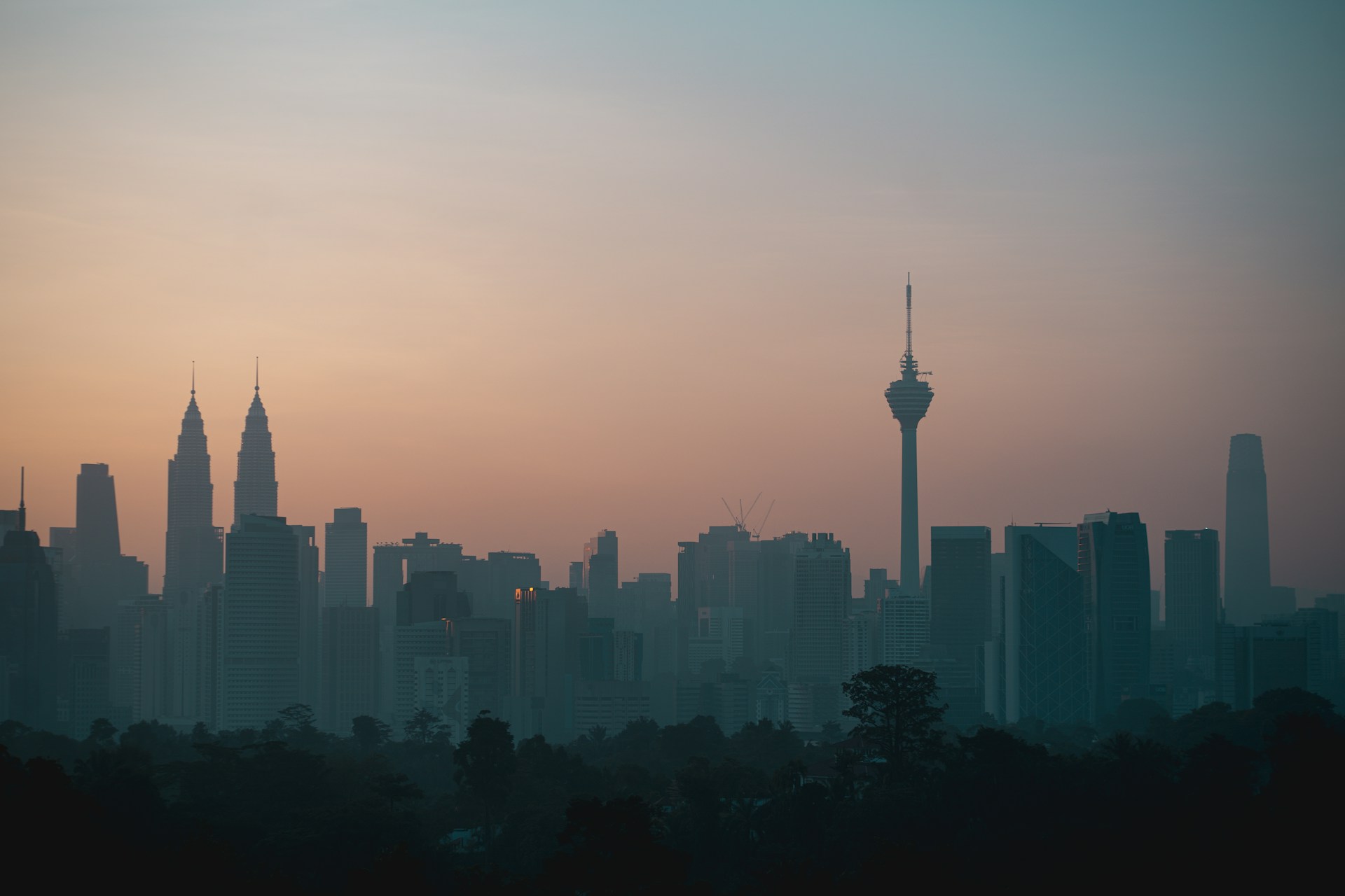 A skyline silhouetted against a colorful sunrise.
