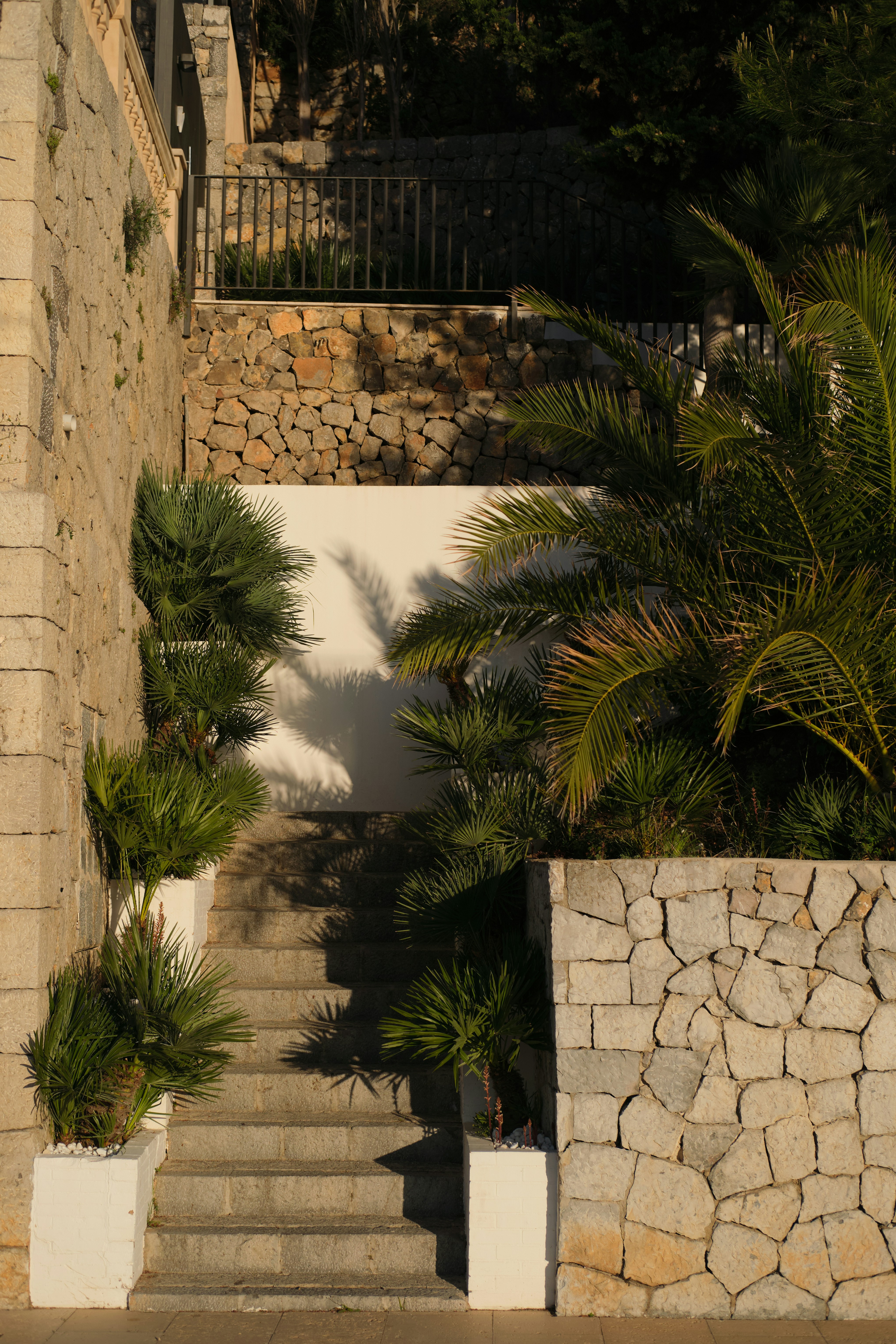 Stone steps lead up to a walled garden.