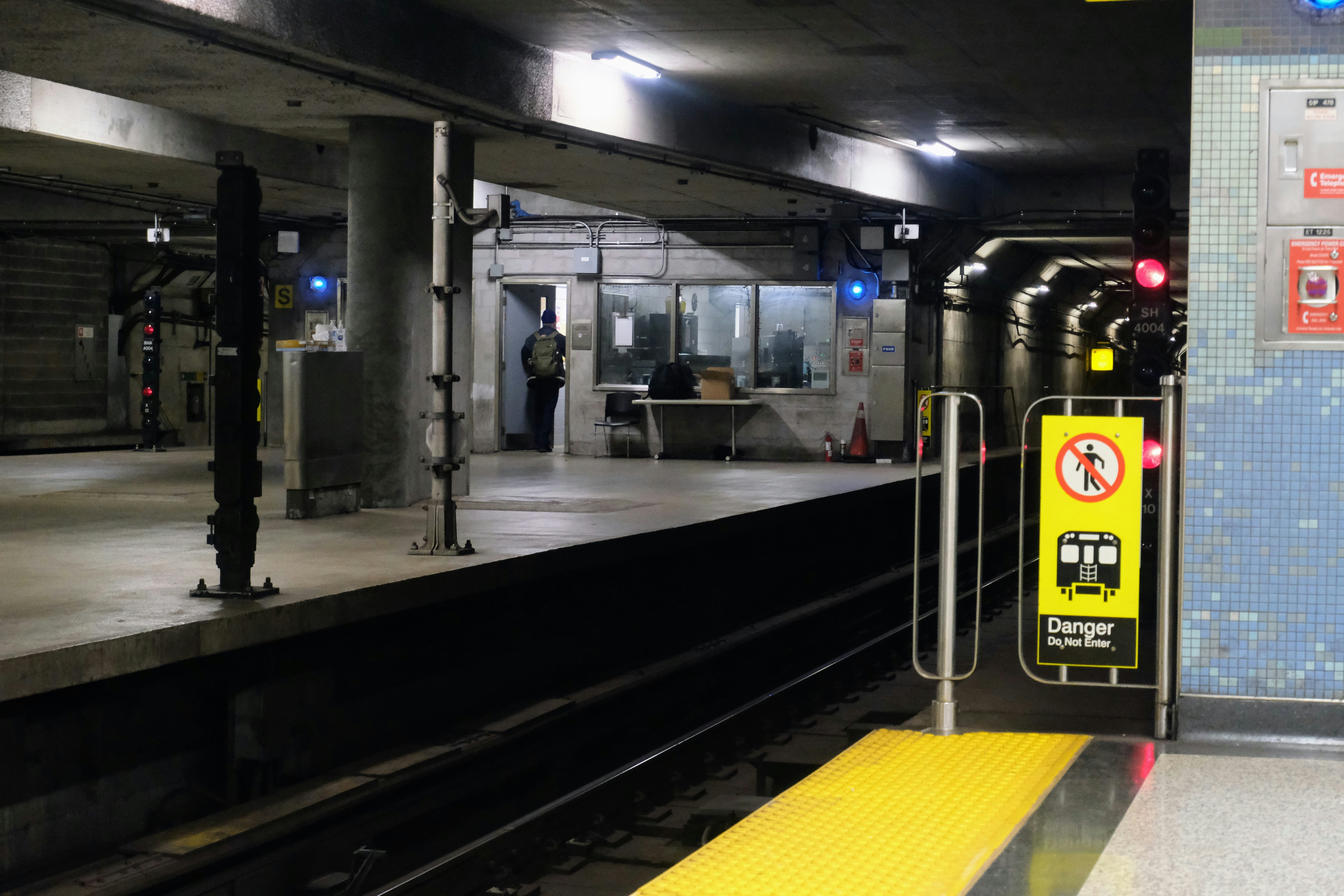 Empty subway platform with safety sign.