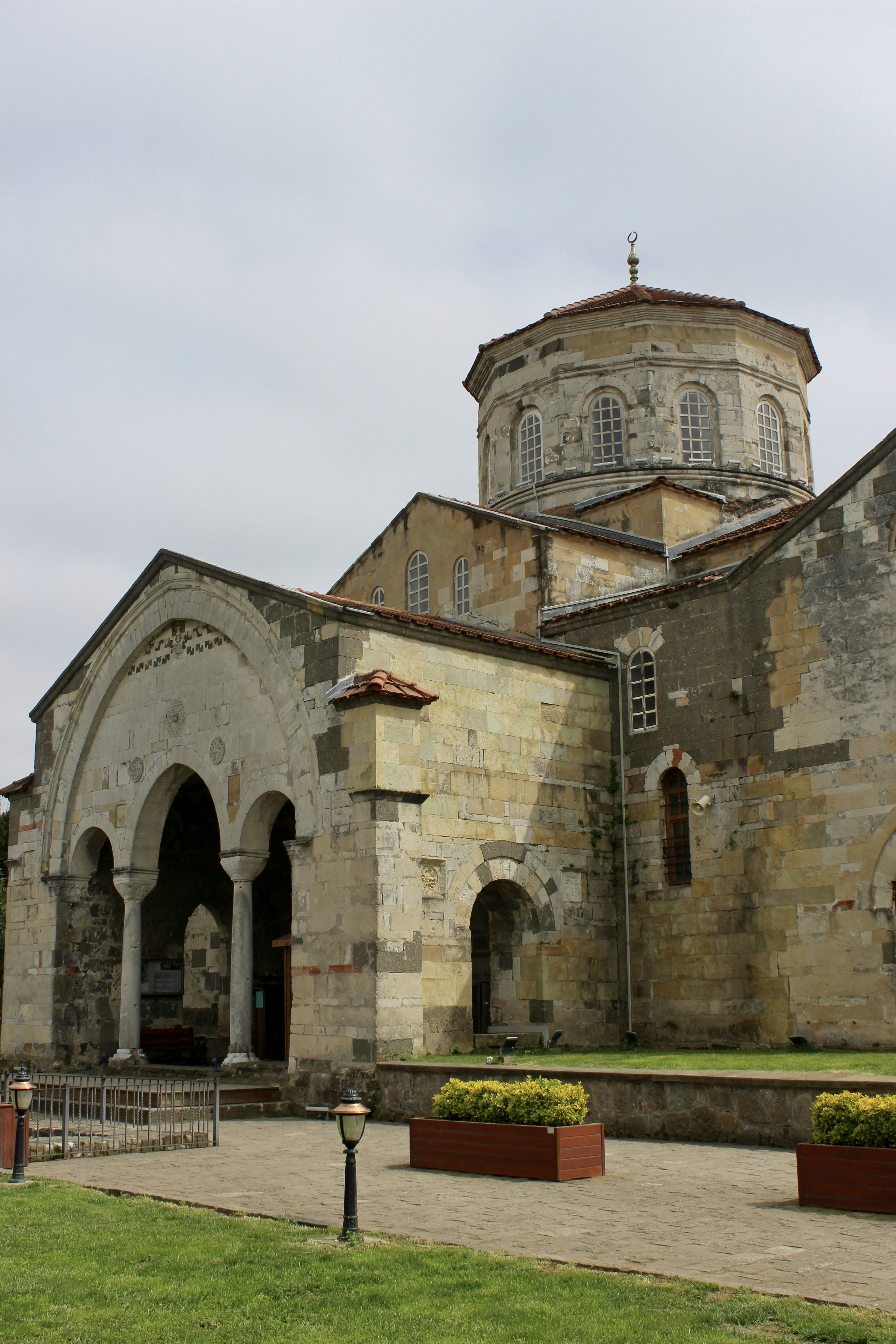 An ancient church with arched entrance and dome.