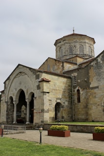 An ancient church with arched entrance and dome.