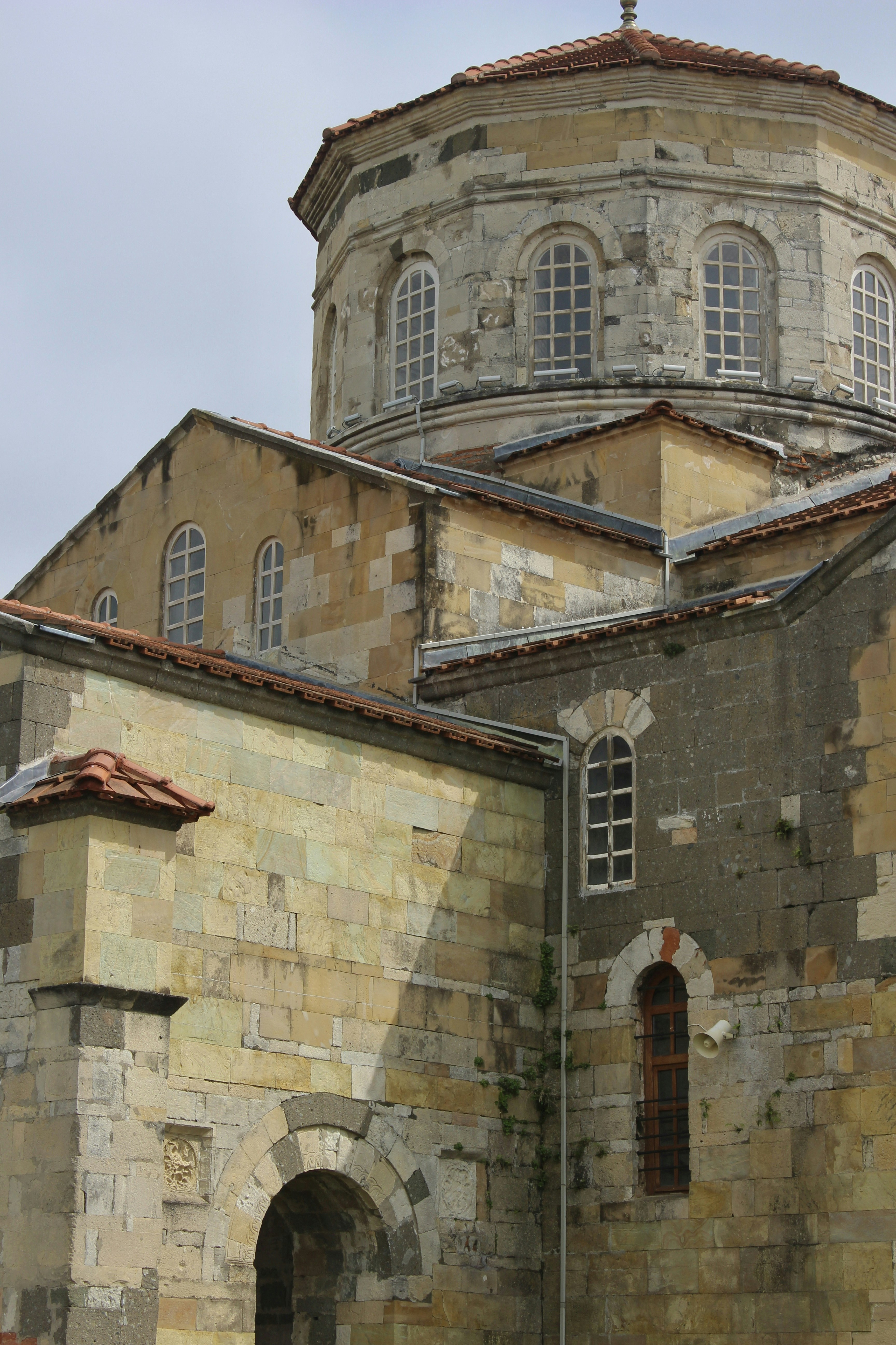 An ancient stone church with a dome.