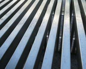Parallel, metallic lines create a textured surface.