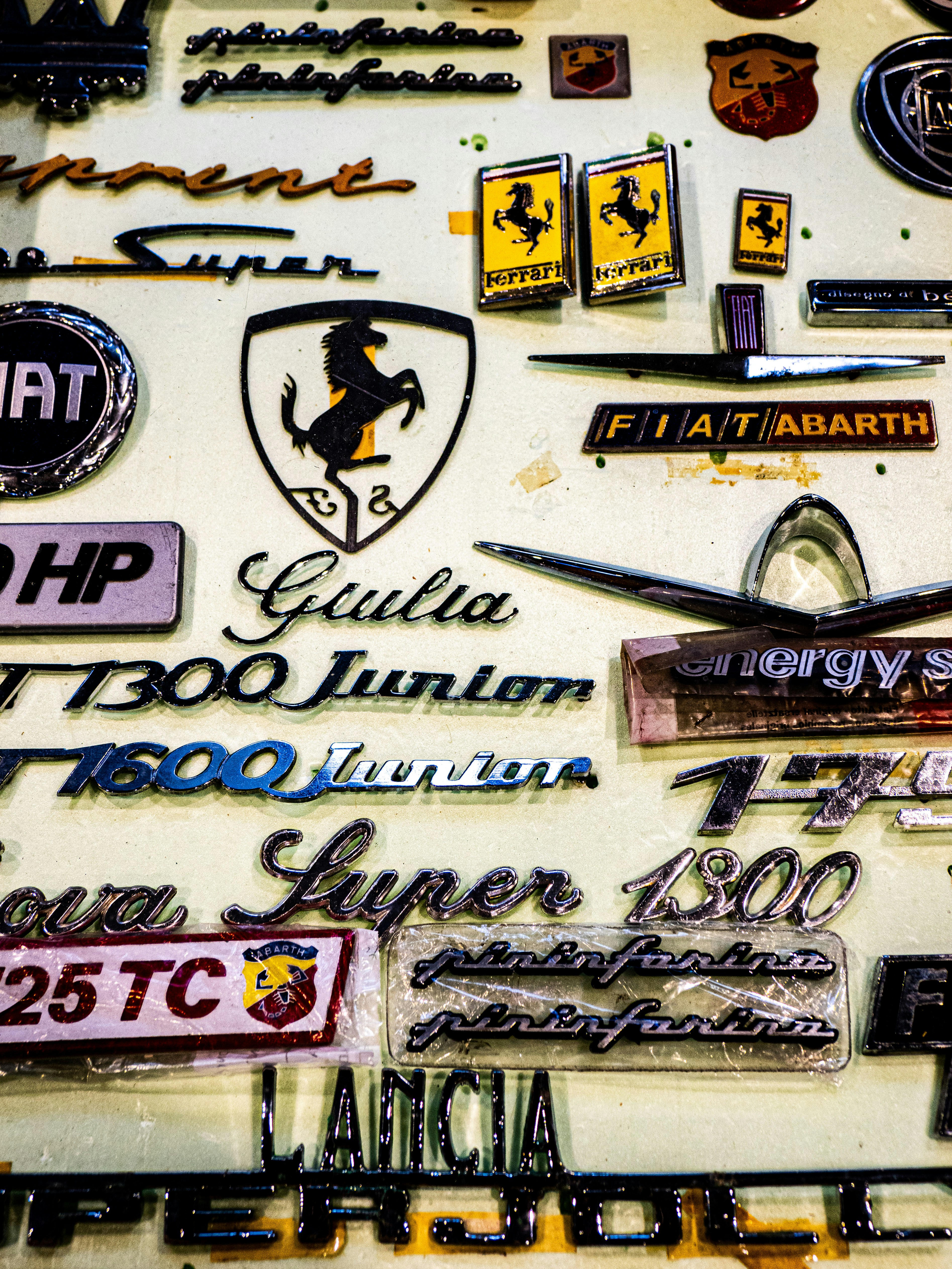 Vintage car emblems and badges are displayed.
