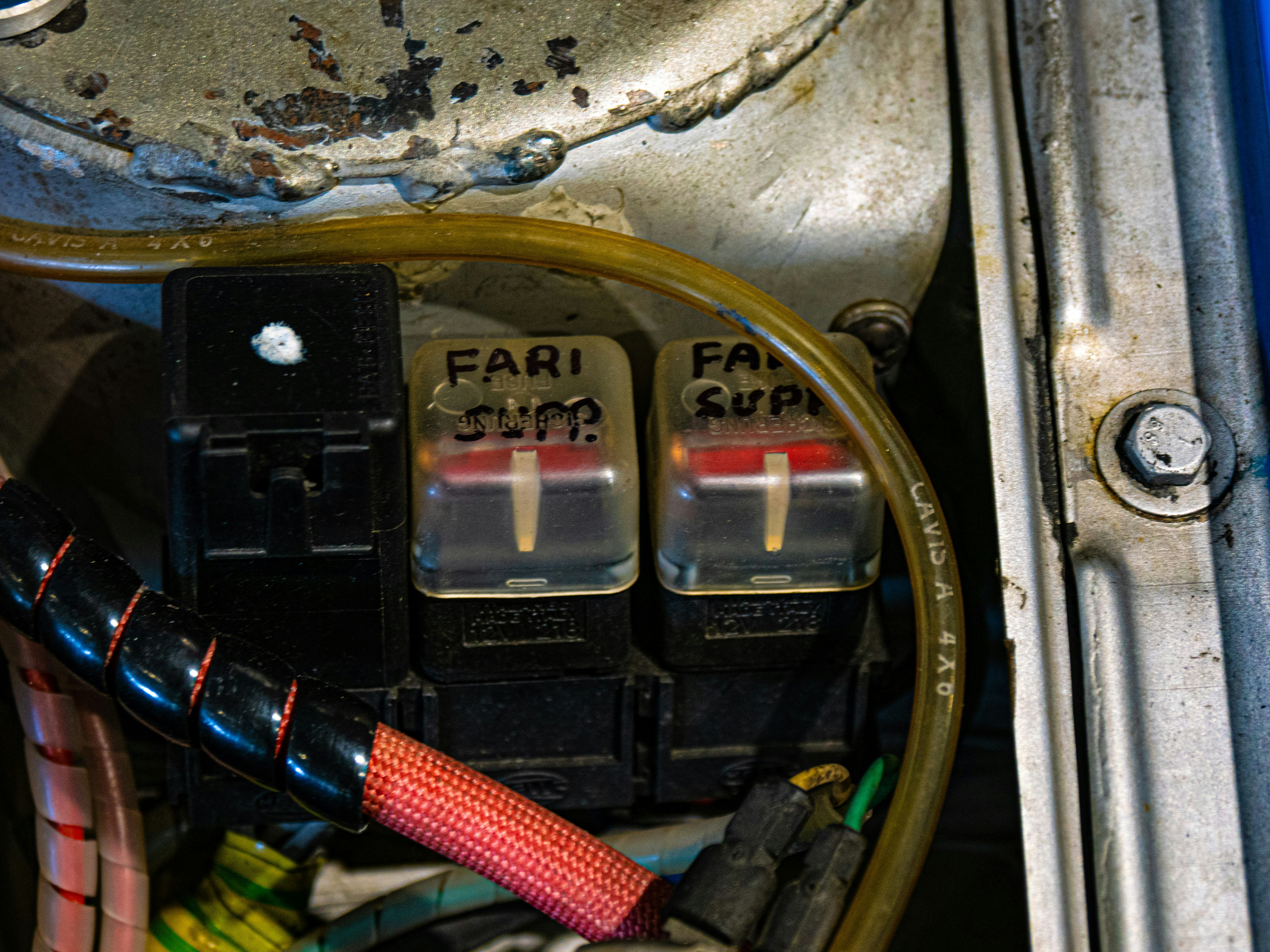 Closeup of a DC fast charging connector plugged into an electric vehicle at a public station
