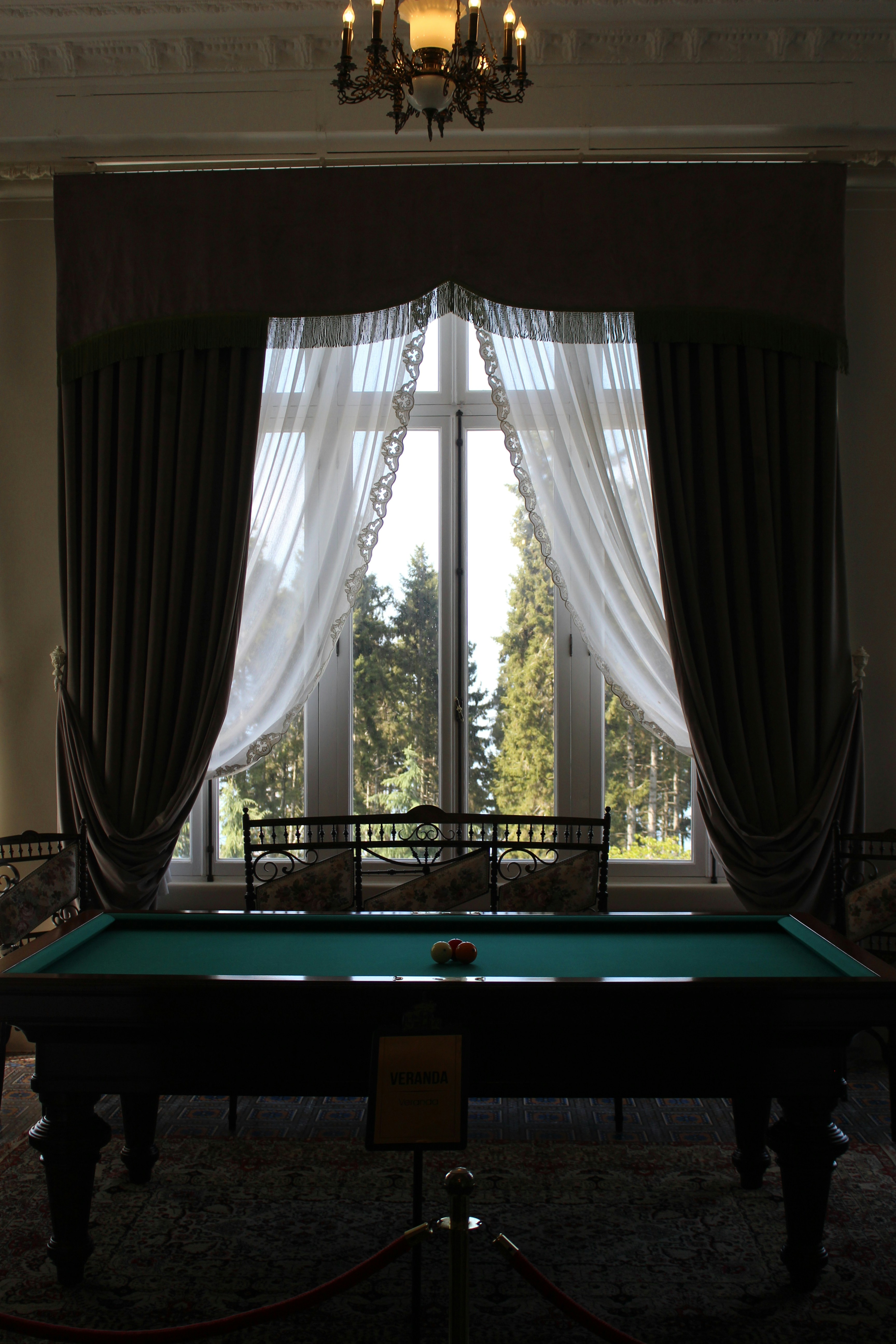 A billiard table is illuminated by sunlight.
