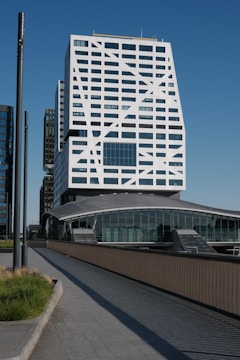 Modern architectural building stands tall against a blue sky.