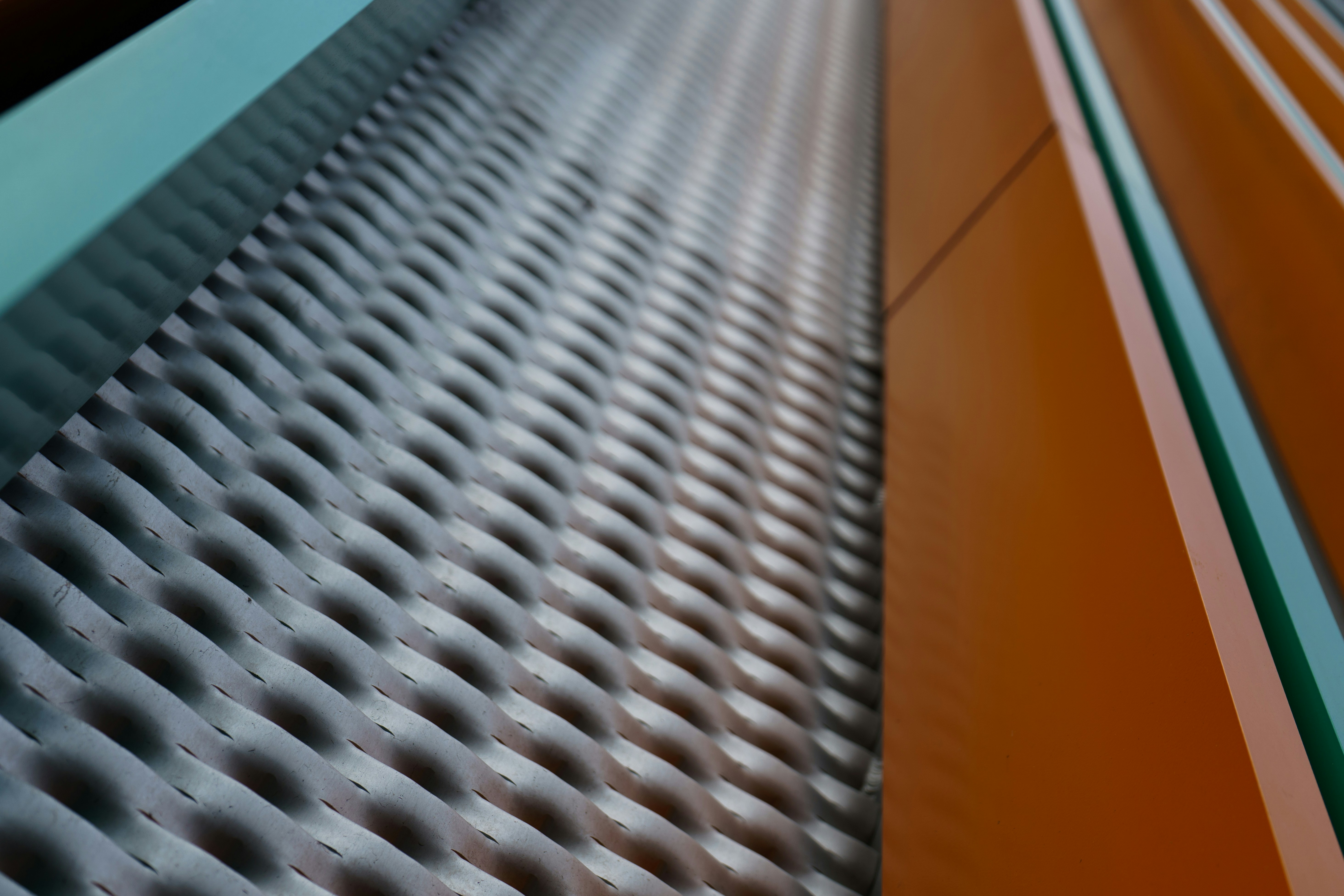 A metal grate and orange wall are visible.