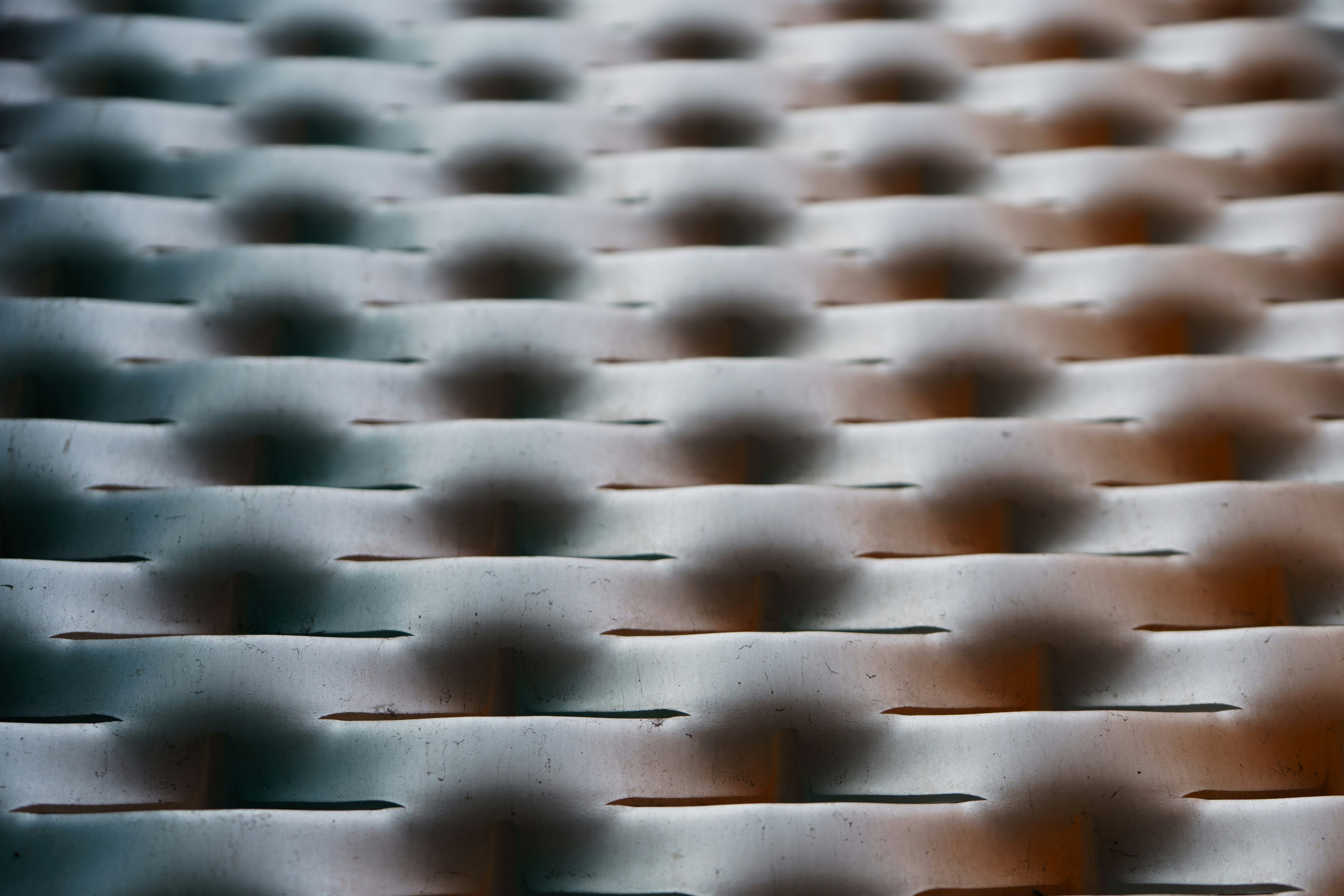 Rows of abstract, textured, bumpy spheres.