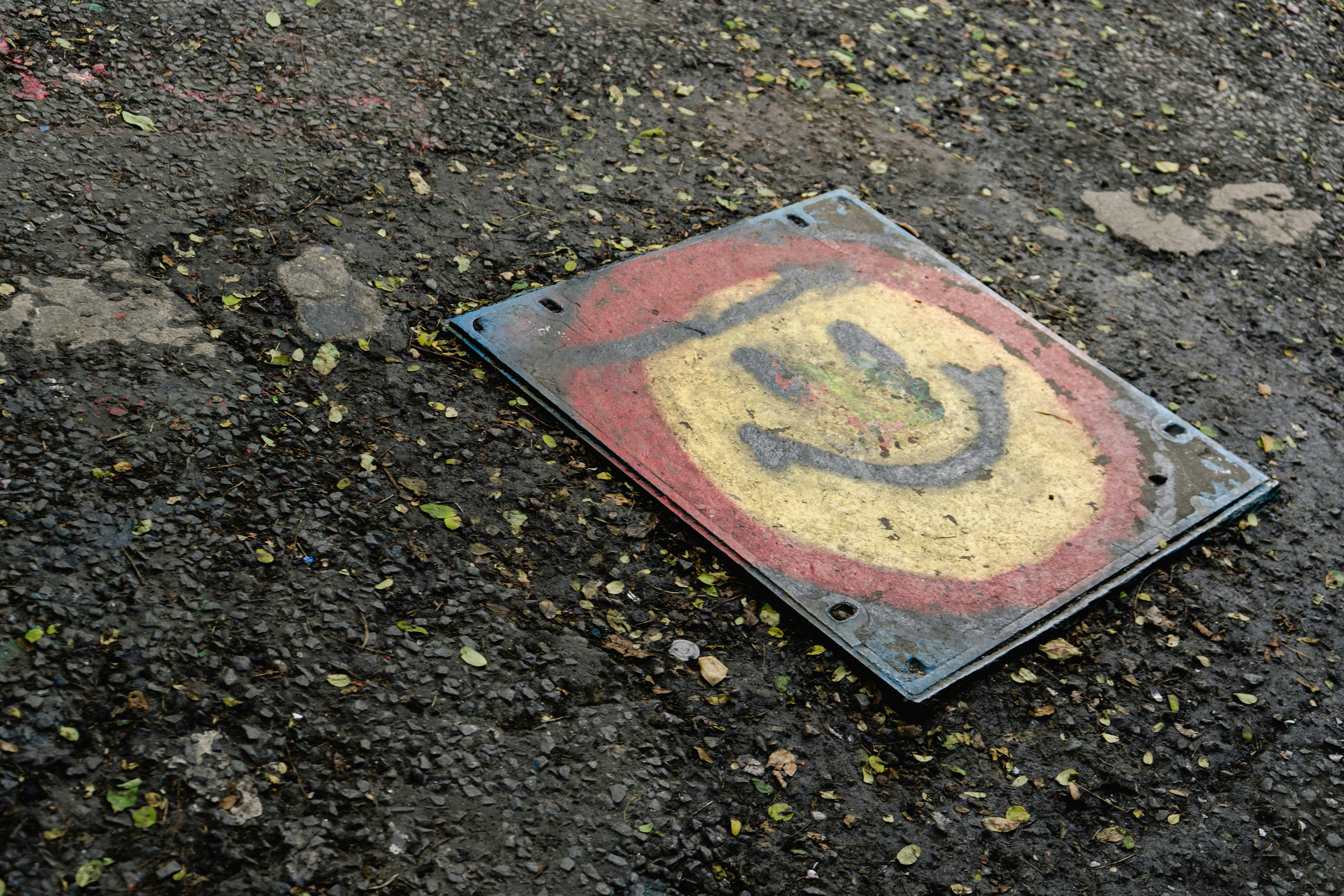 A smiling face on a cement cover.