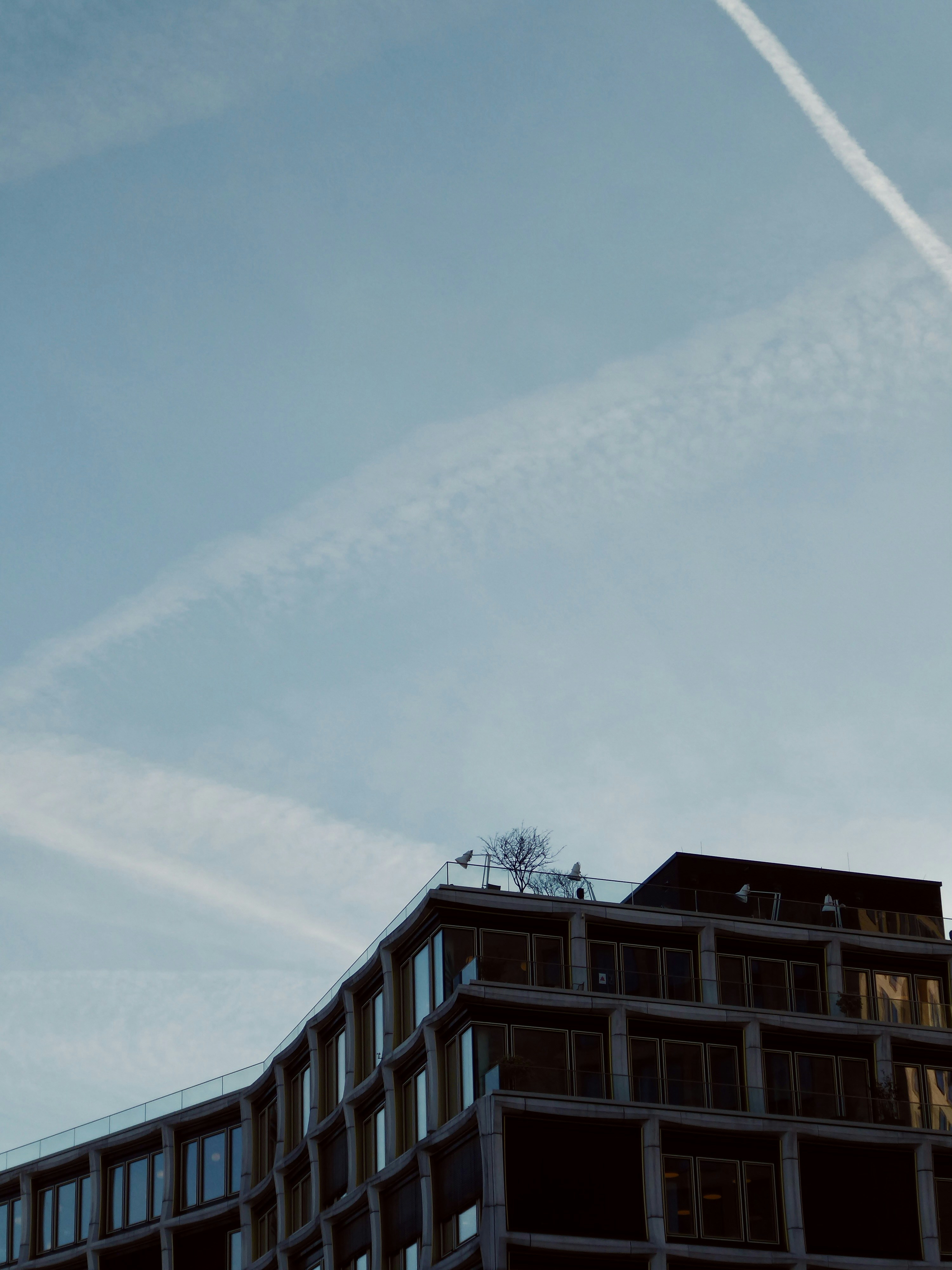 Modern building with blue sky and clouds.