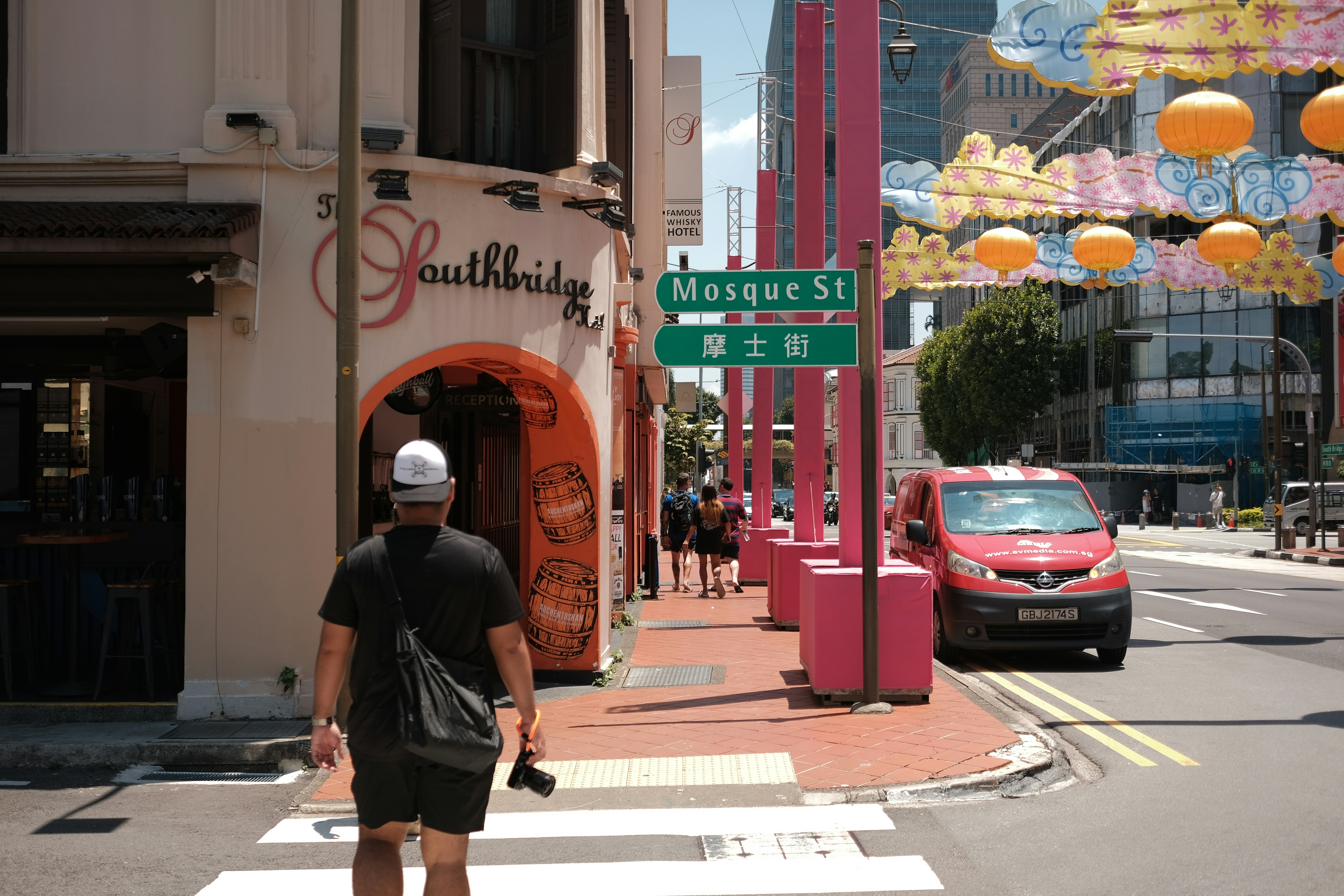 People walk along a street in singapore.