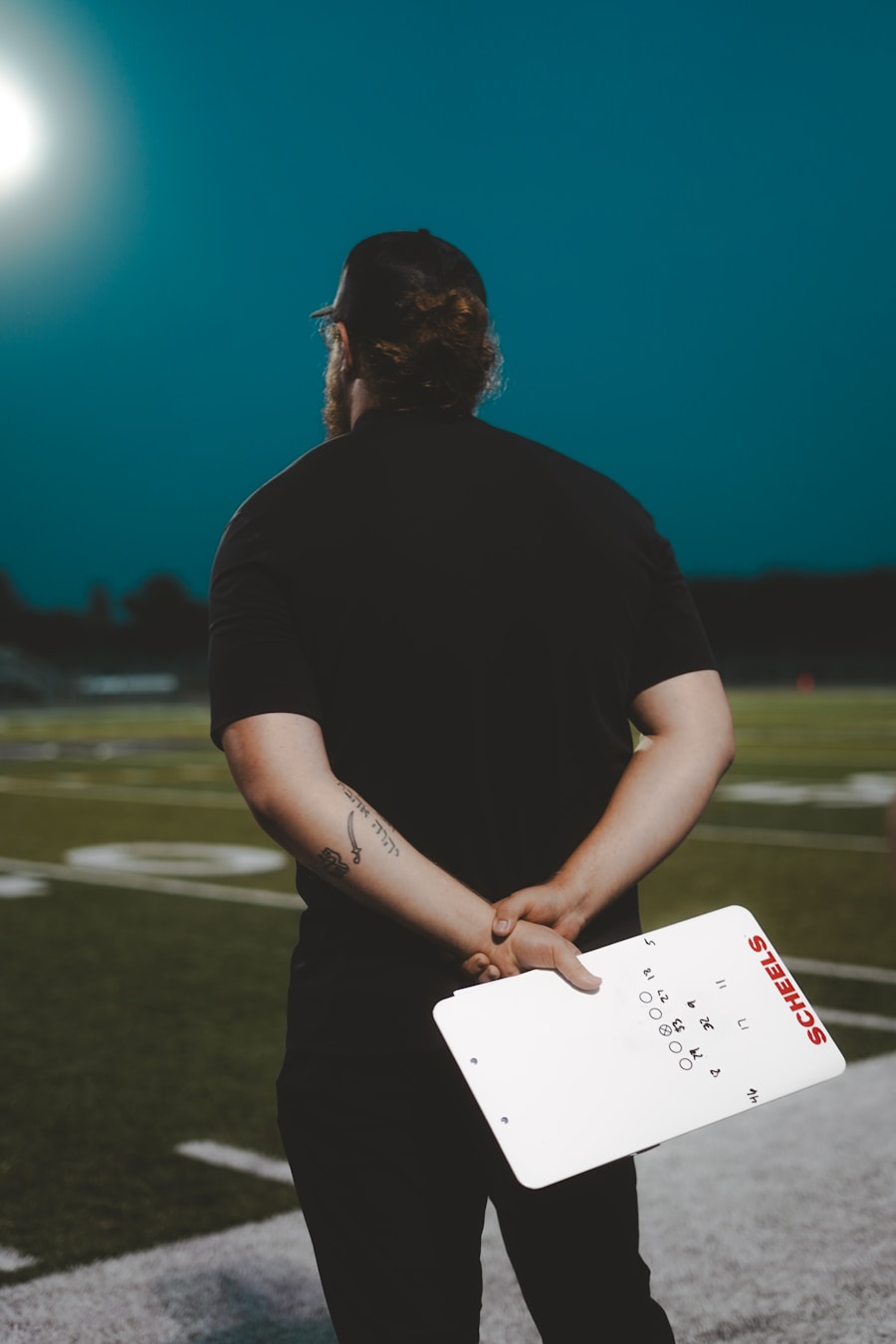 Football coach surveying the field, planning strategy