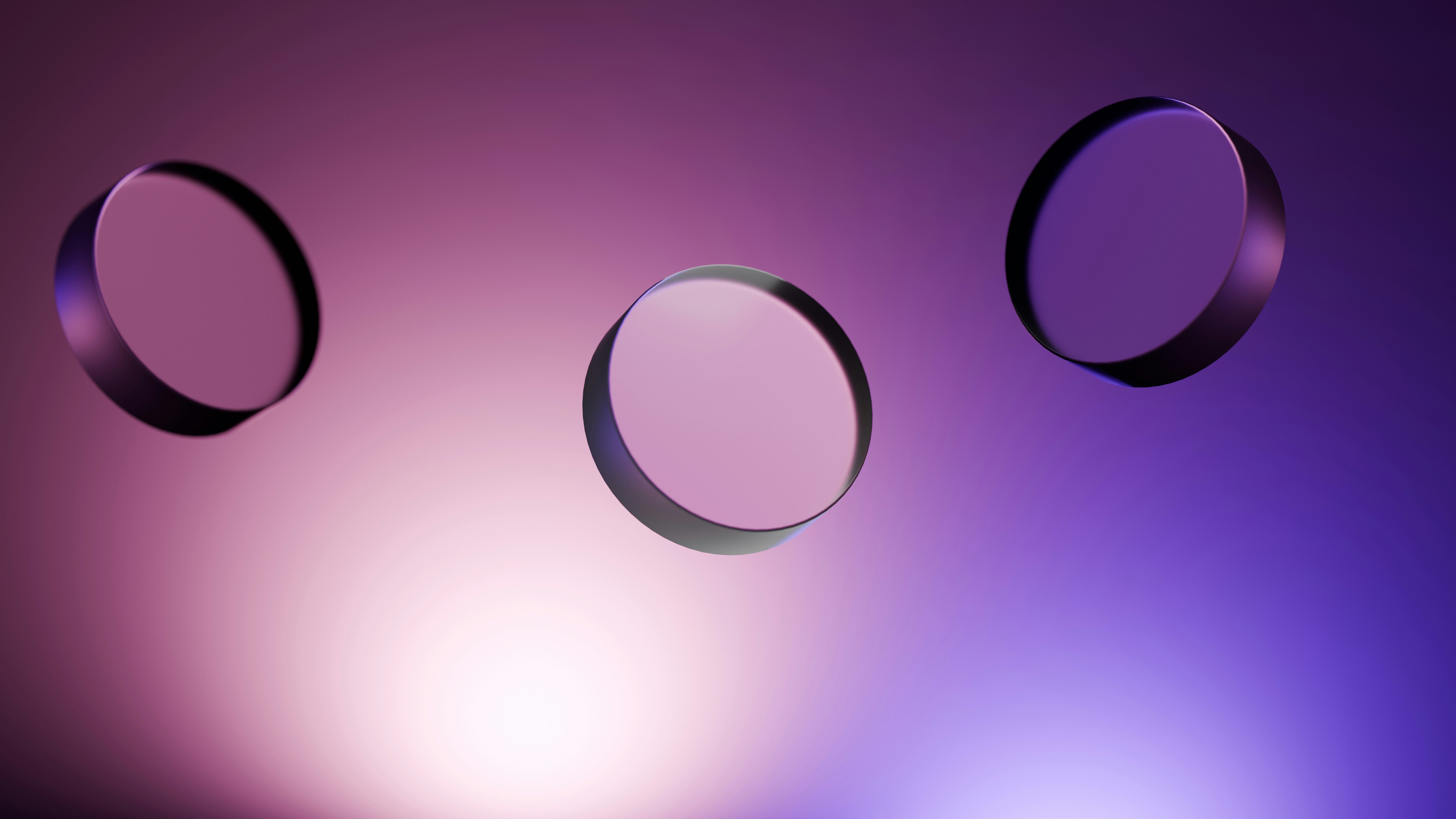 Three round optical lenses are floating.