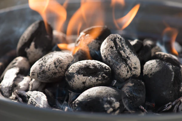 Glowing coconut charcoal briquettes