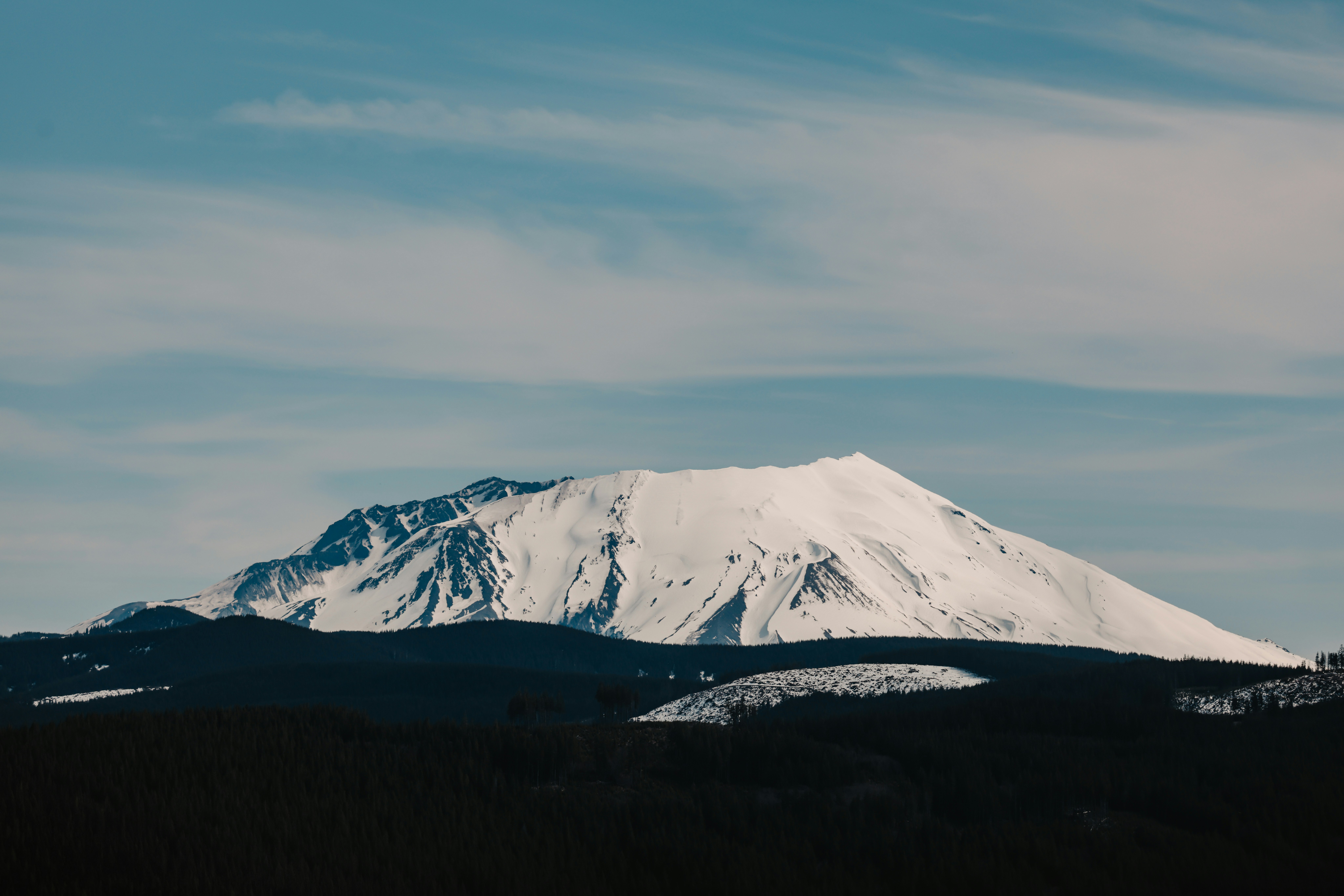 Snow-capped mountain against a blue sky.