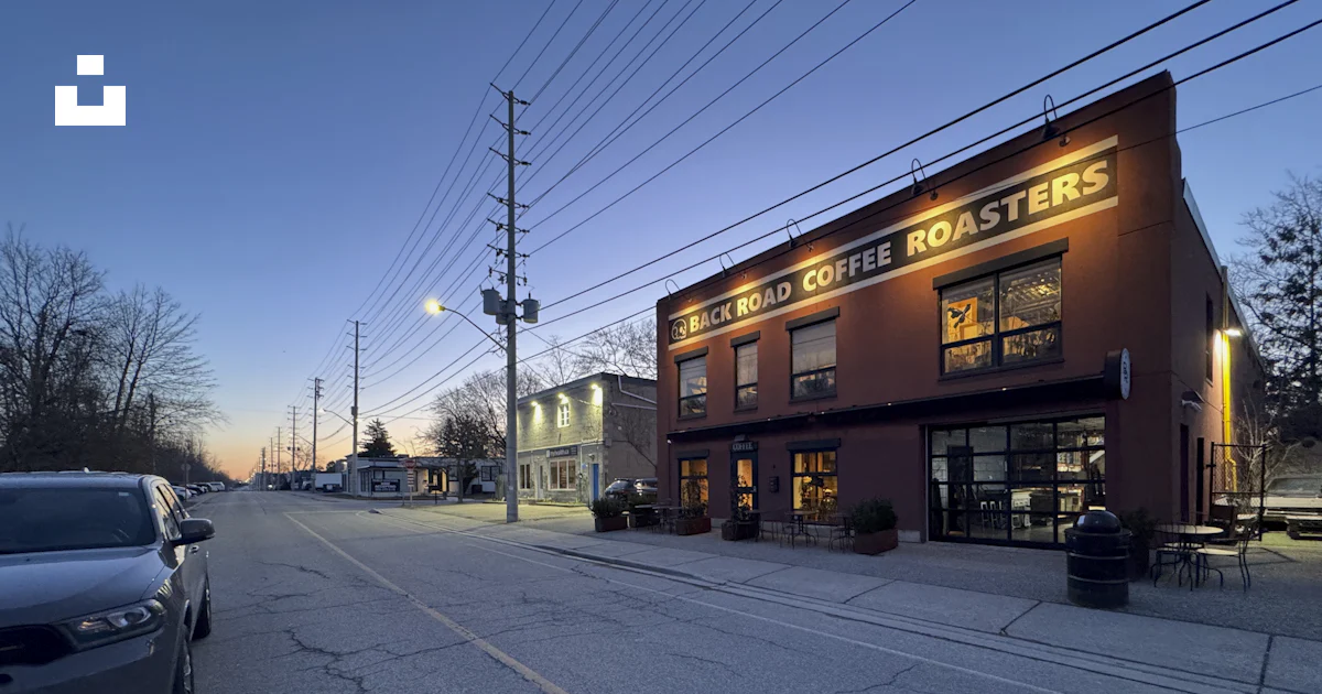 A coffee roasters building on a quiet, blue-lit street. photo – Free ...