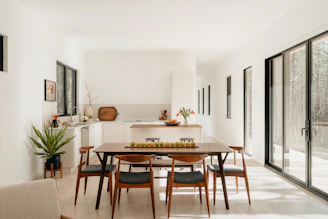 Modern dining room with table, chairs, and kitchen