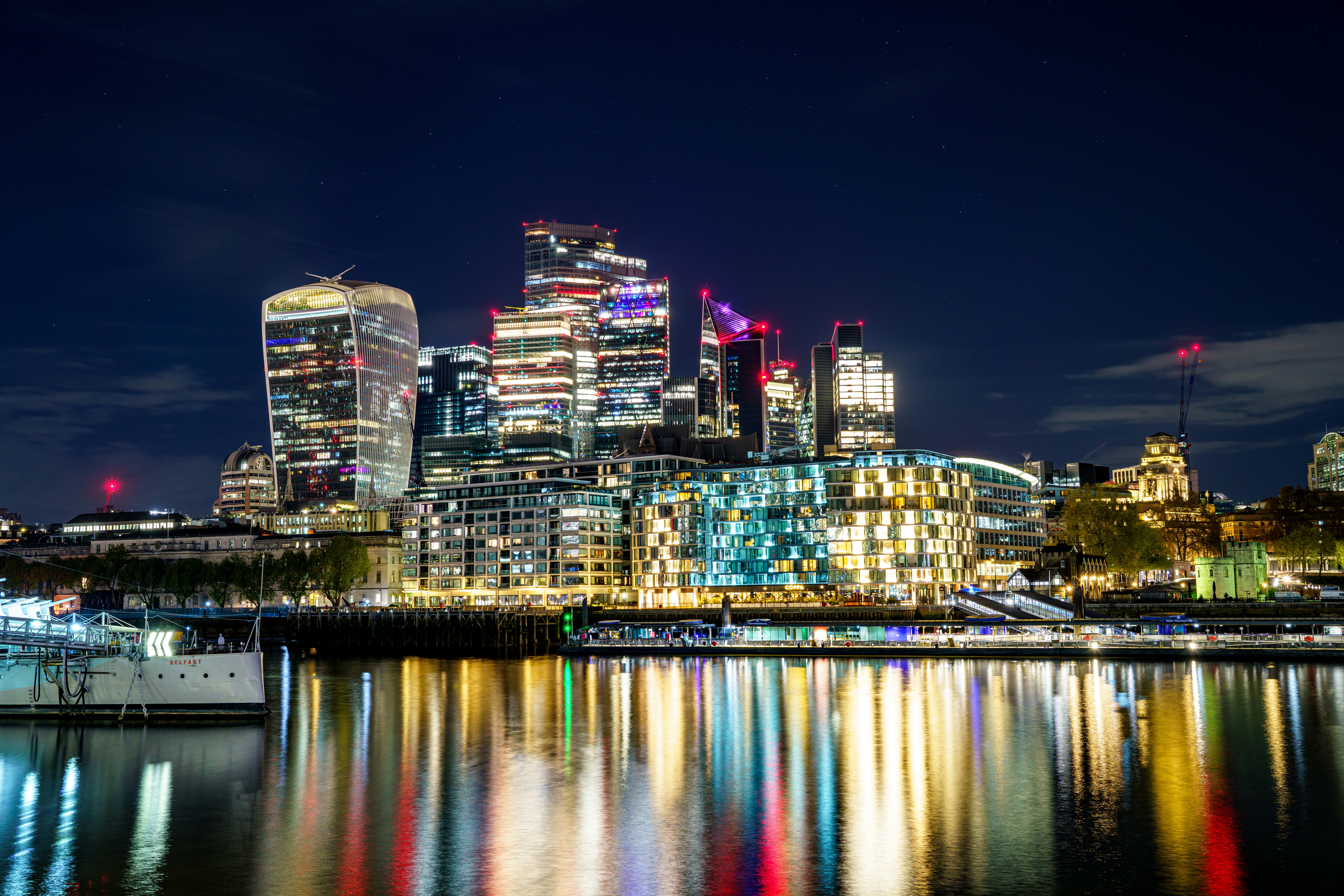 City skyline reflecting in the water at night.