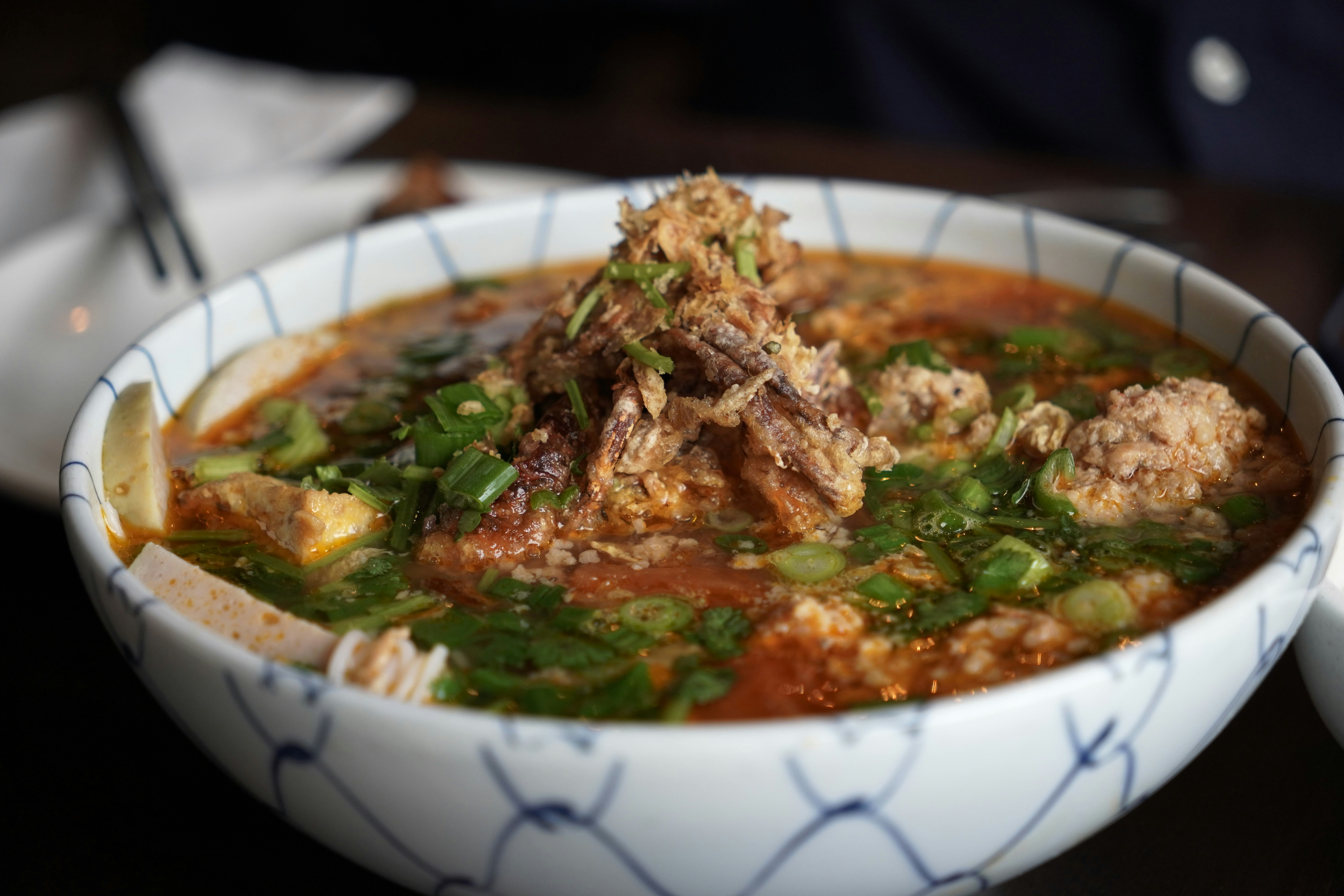A bowl of delicious soup with garnish.