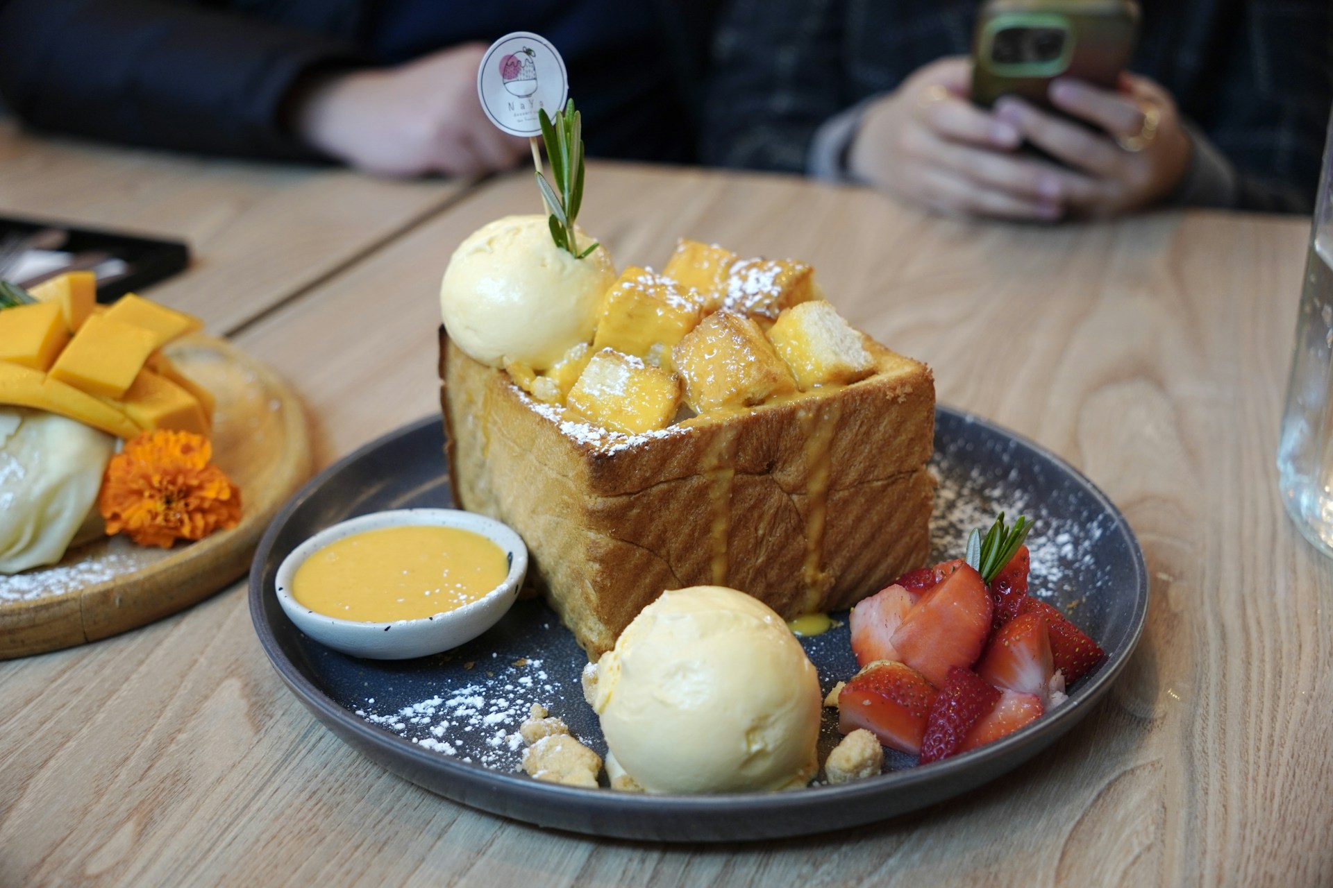 Delicious dessert of toast, mangoes, and ice cream.