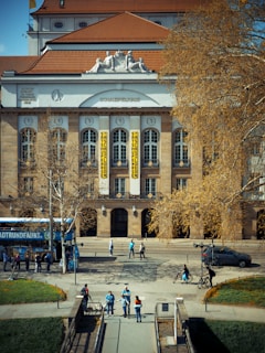 A gorgeous building with people walking around.