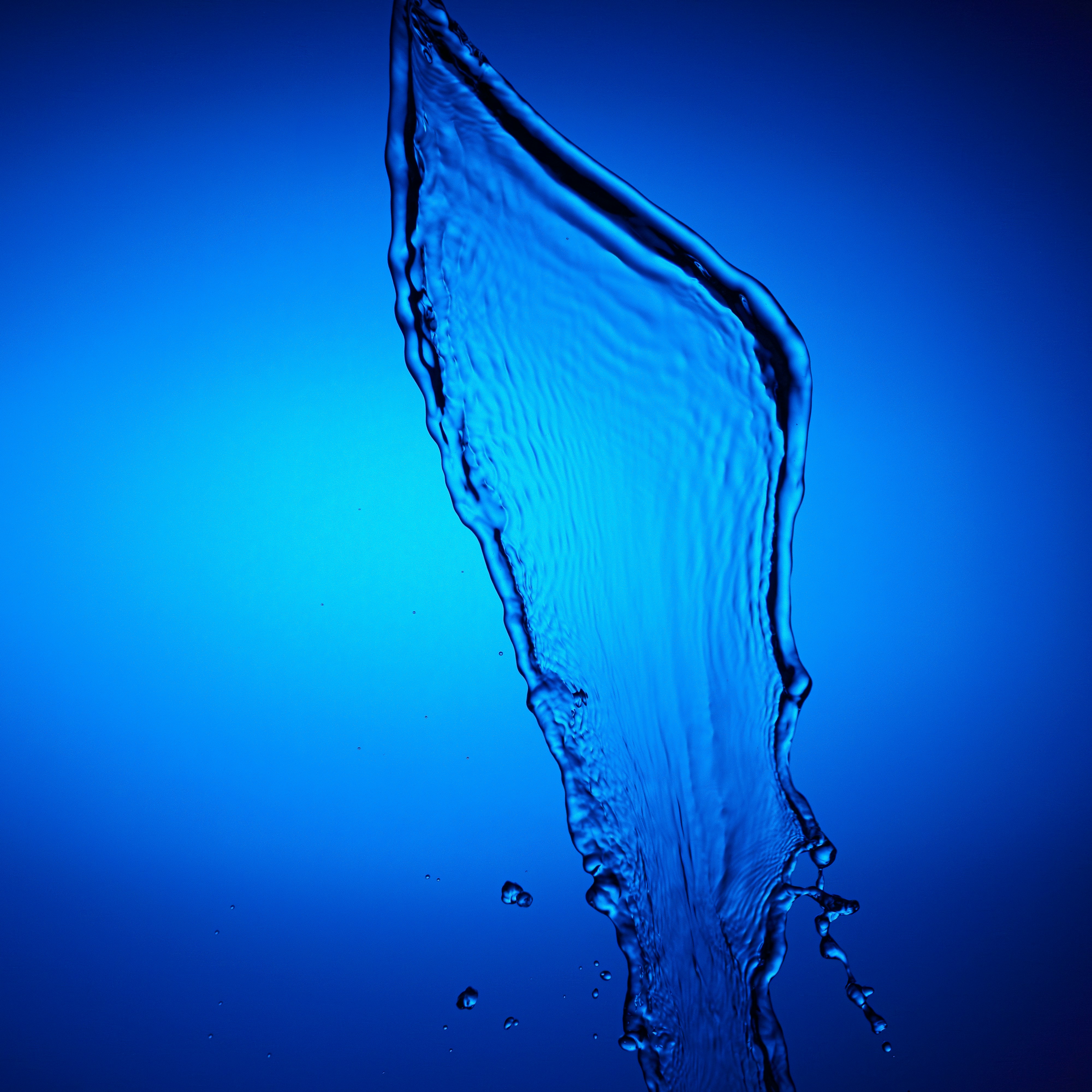 A splash of water against a blue background. photo – Free Abstract ...