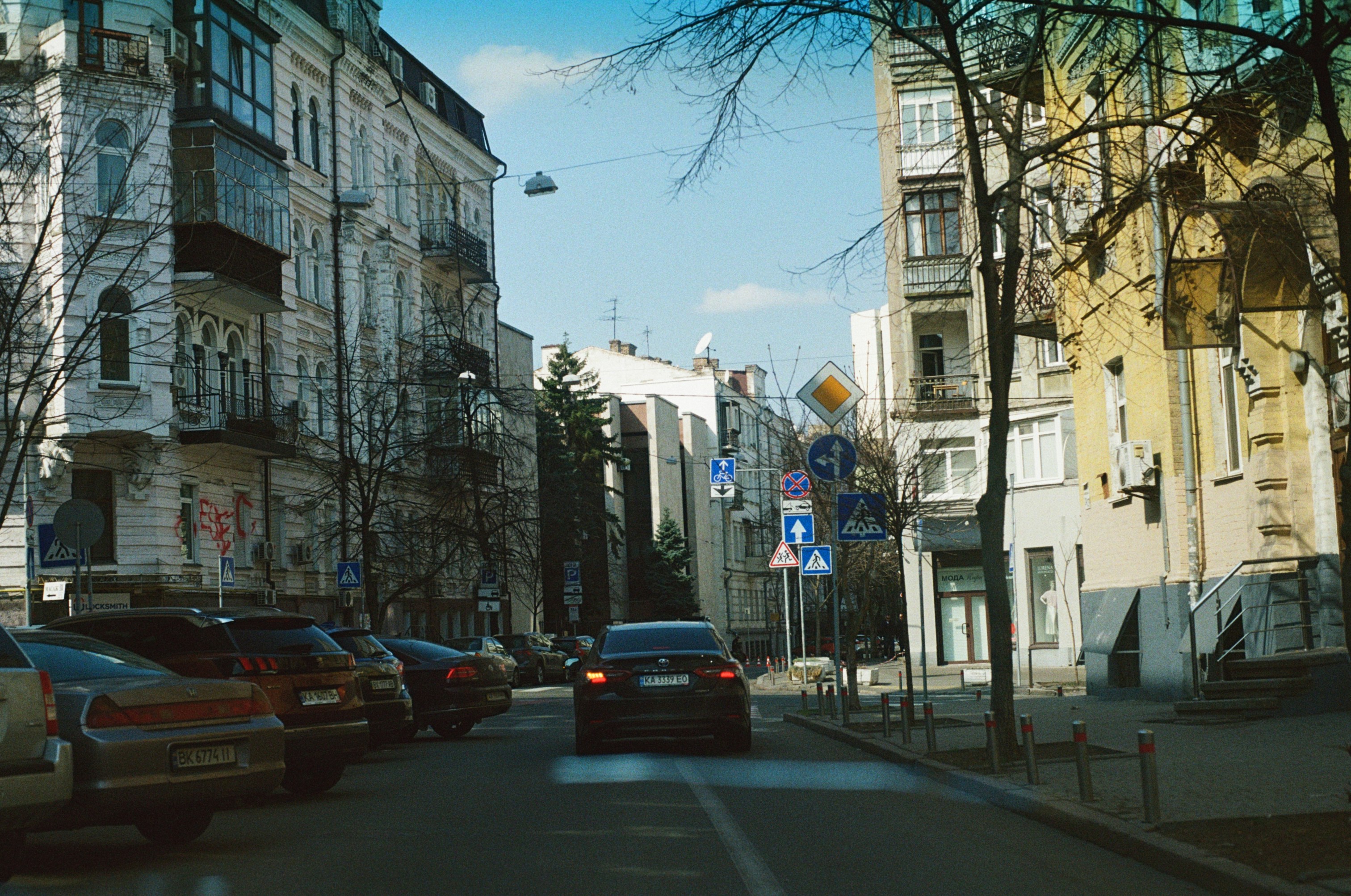 A modern city street scene with a vintage, sepia-toned filter applied.