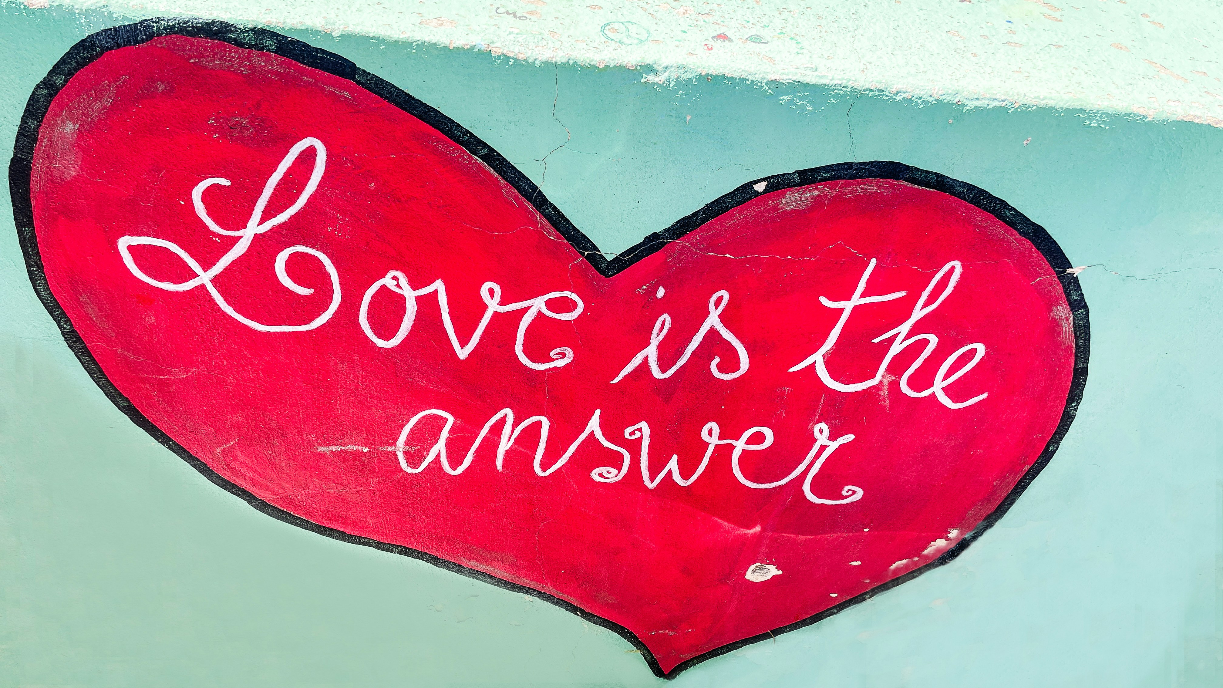 Love is the answer, written on a heart.