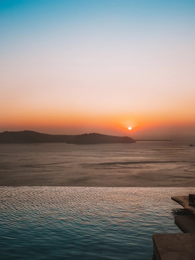 Infinity pool terrace at sunset over the Cretan sea