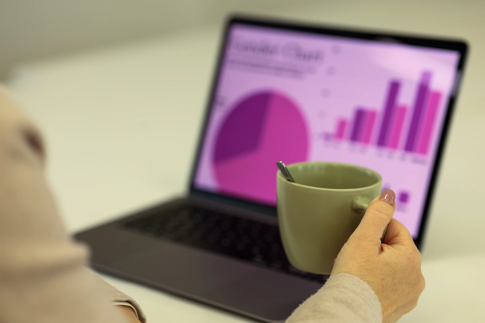 Person working on a laptop with a cup of coffee