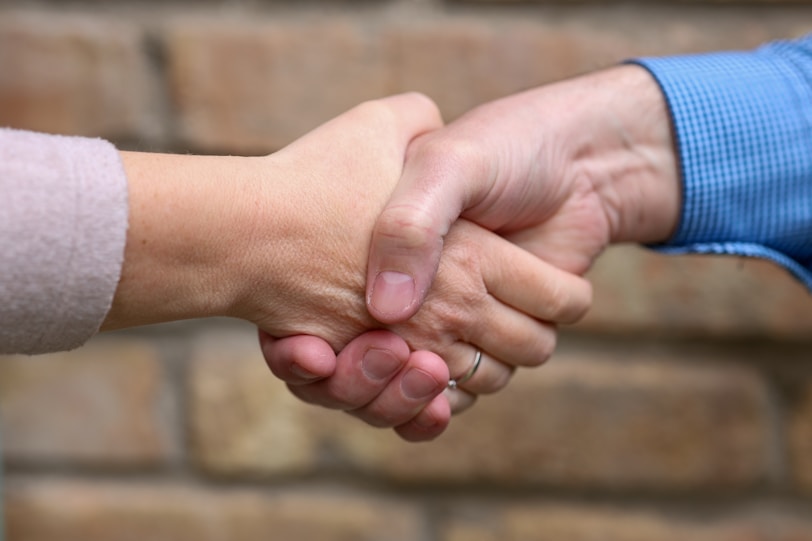 Two people are shaking hands.