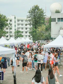 A busy street fair is bustling with many people.