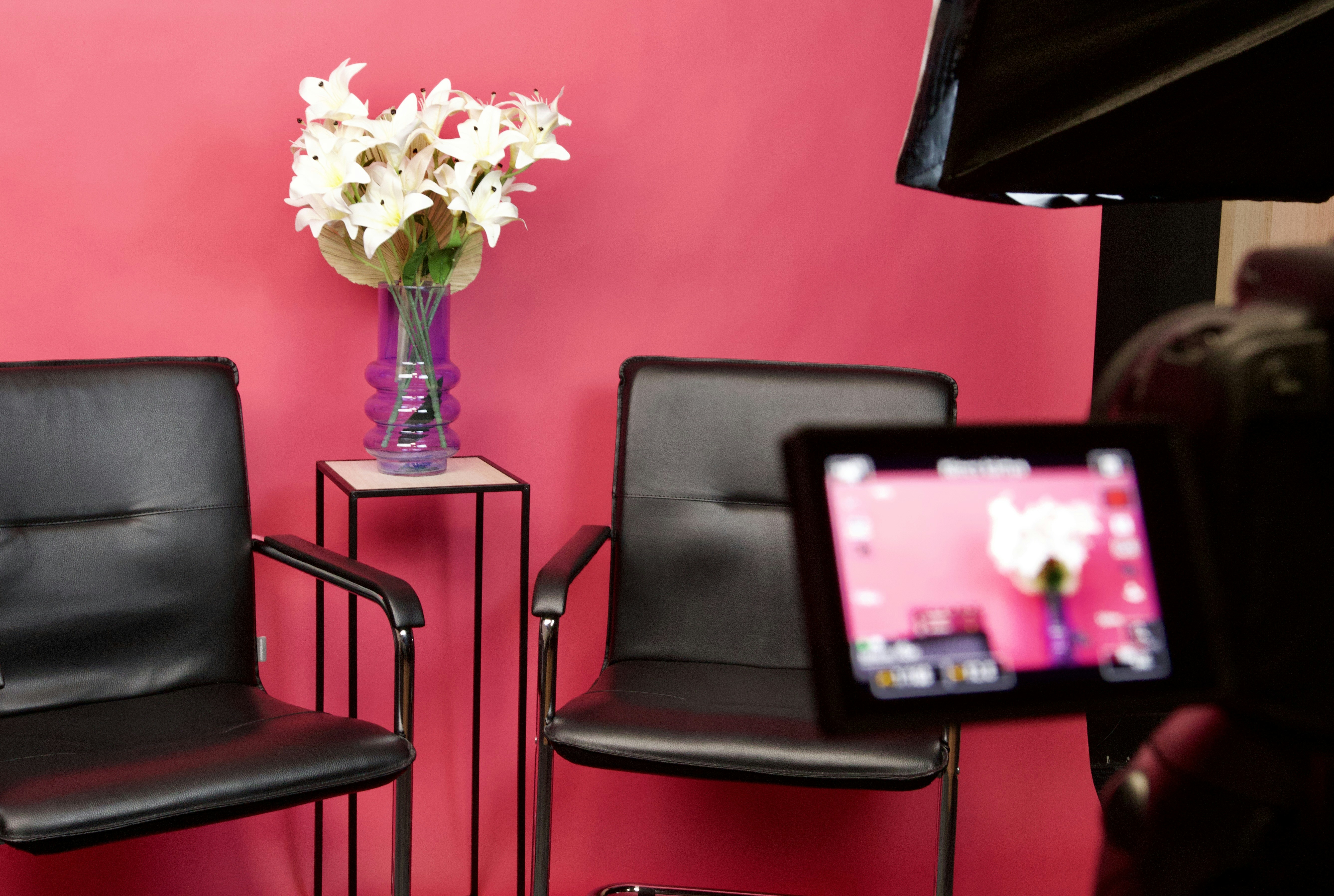 Photography setup with chairs and flowers