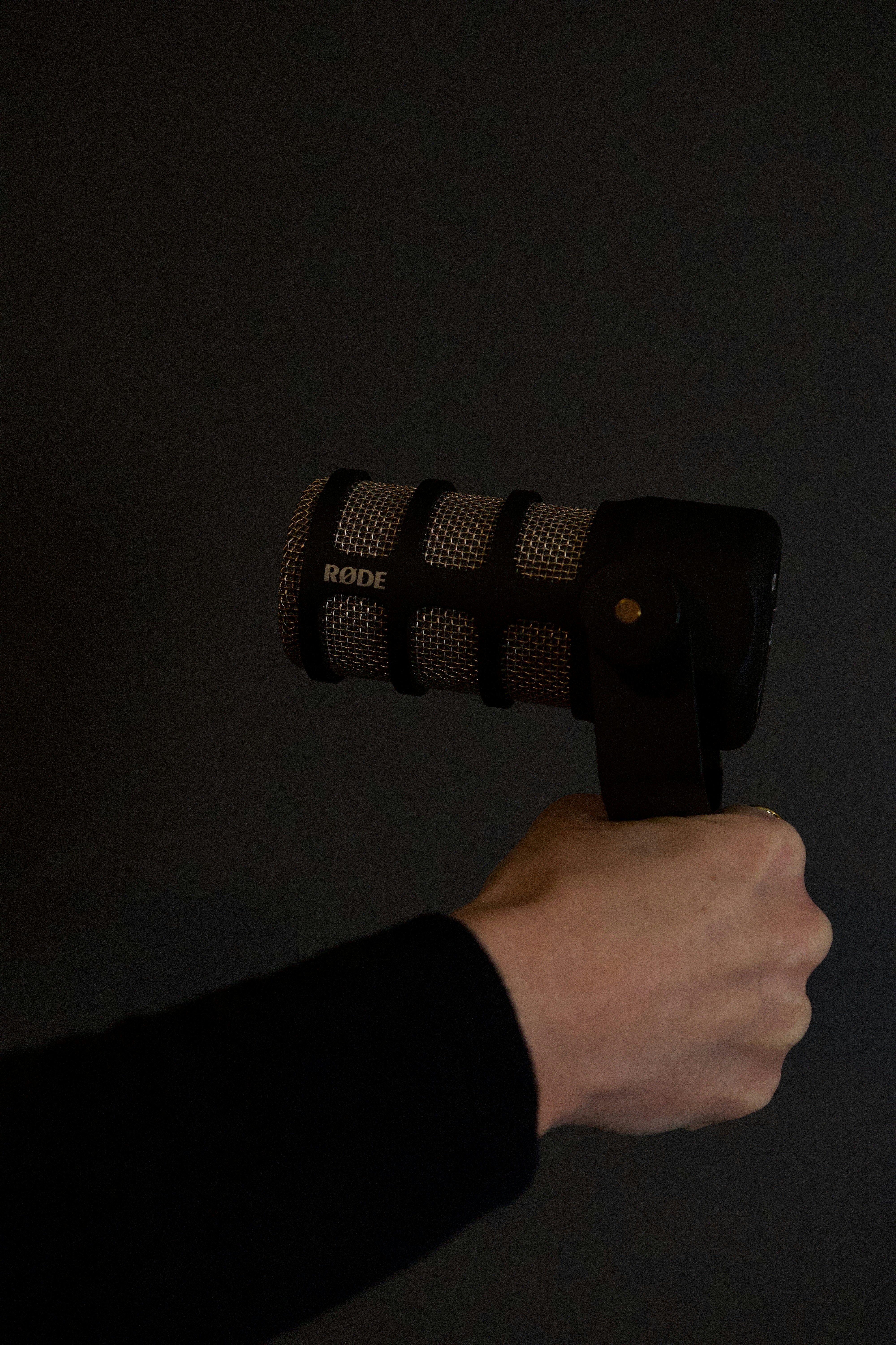 A person holds a microphone.