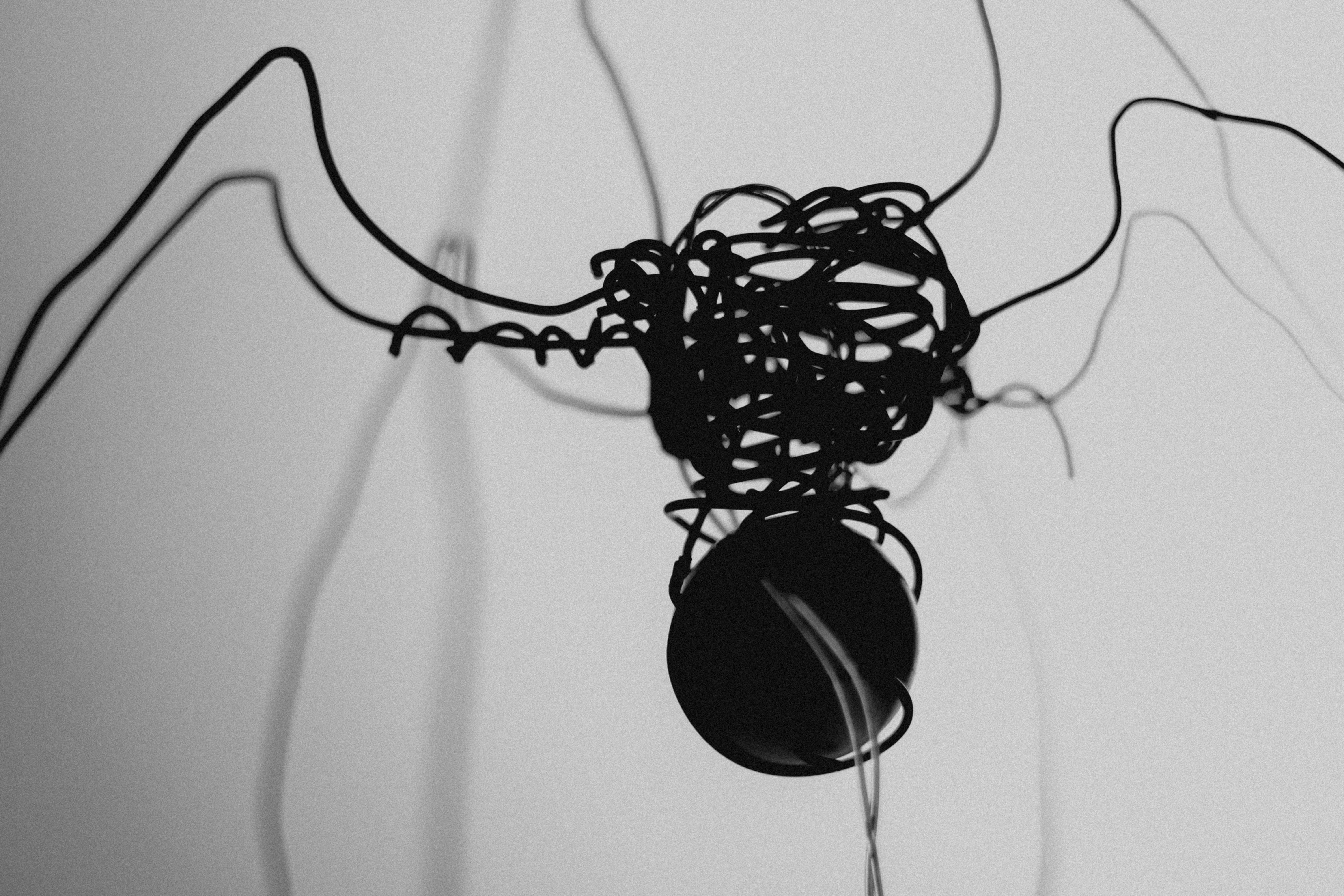 a cartoon illustration of a sad sausage made of wilted noodles and cheese, with tears dripping, minimalist black and white line art