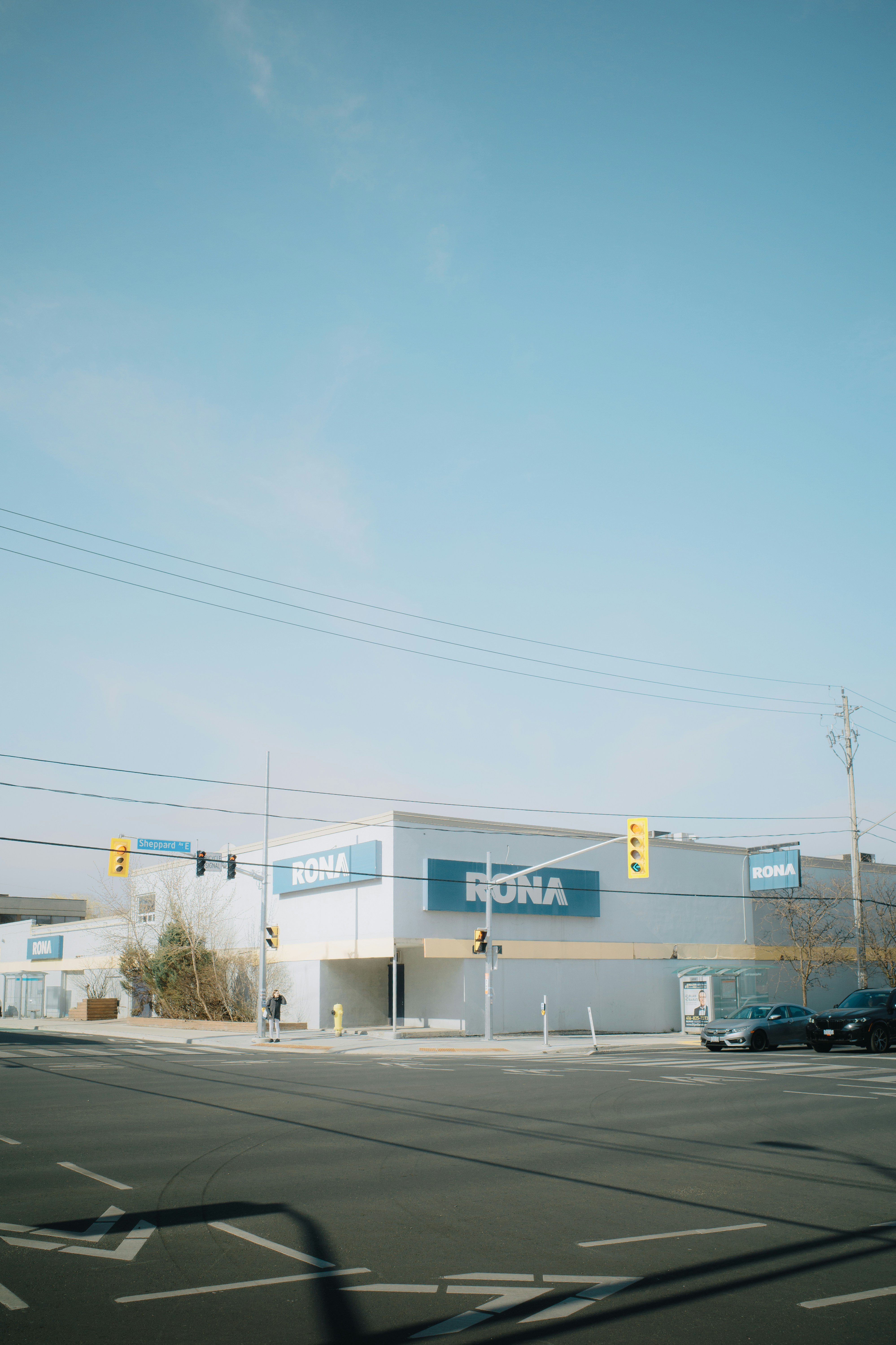 A rona hardware store stands on a clear day.