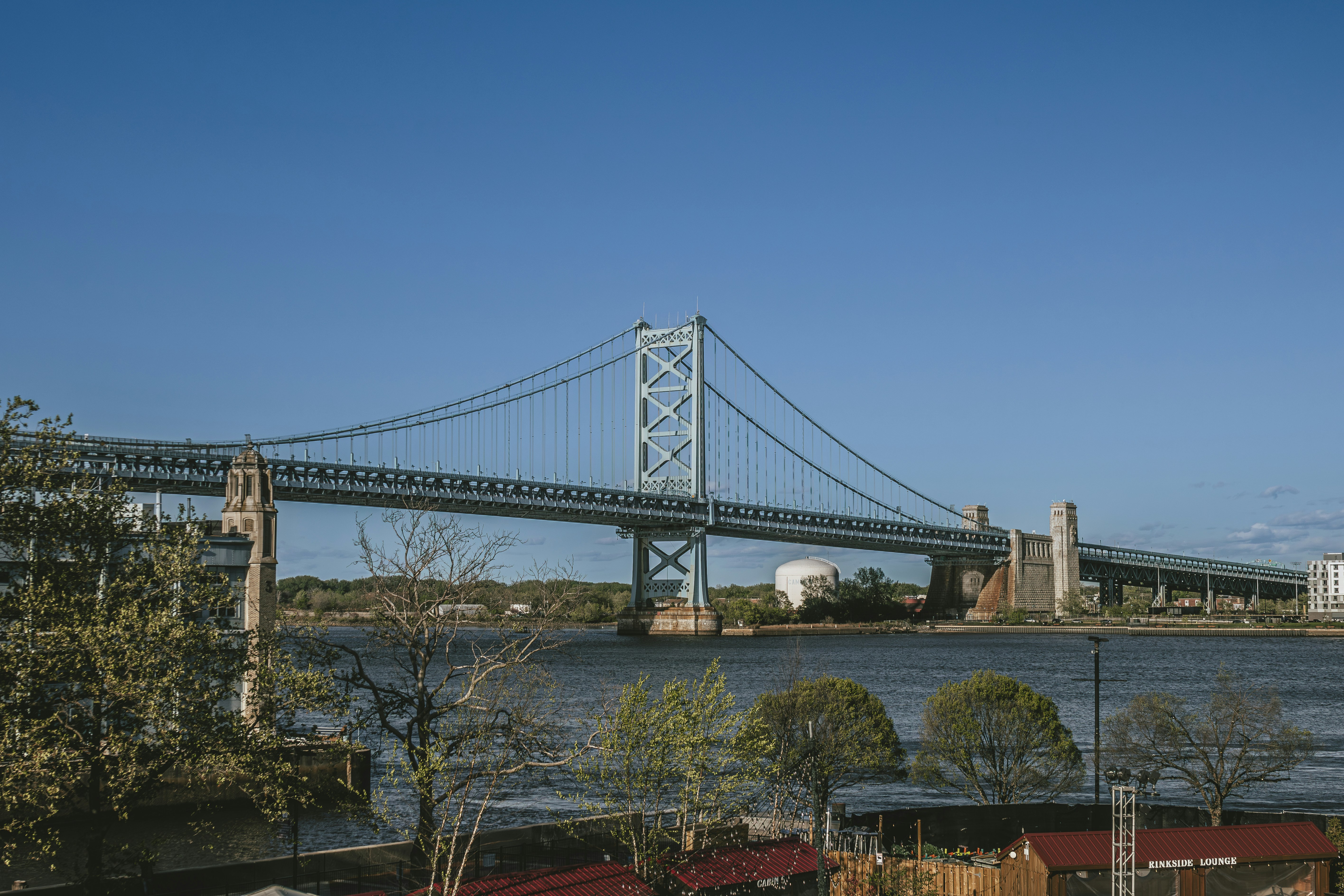 A suspension bridge stretches over water.