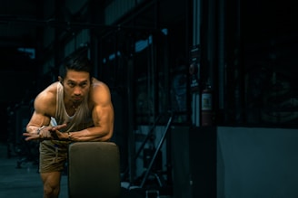 Muscular man rests at the gym.