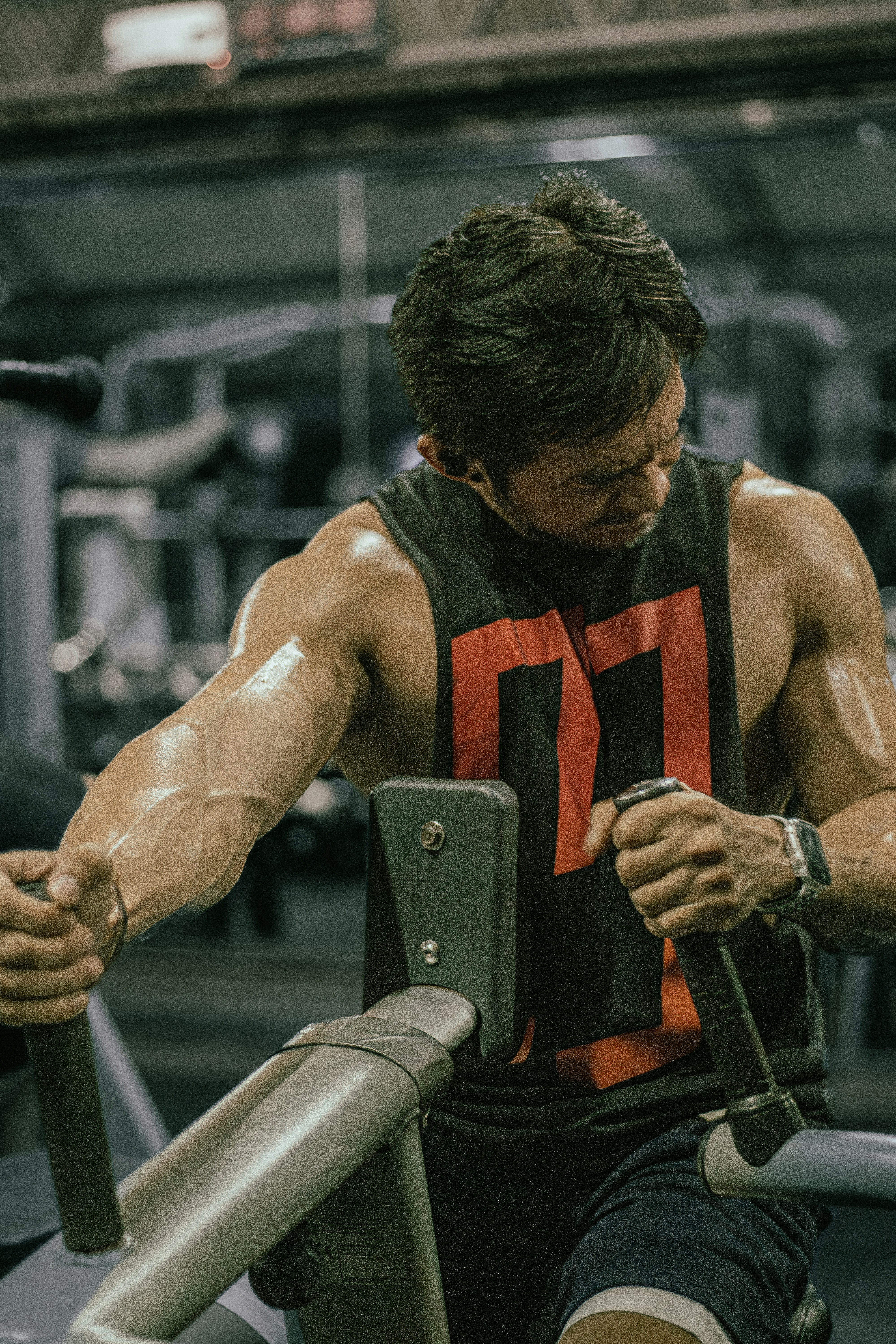 Man works out with weights at the gym.
