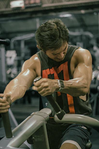 Man trains his muscles at the gym.