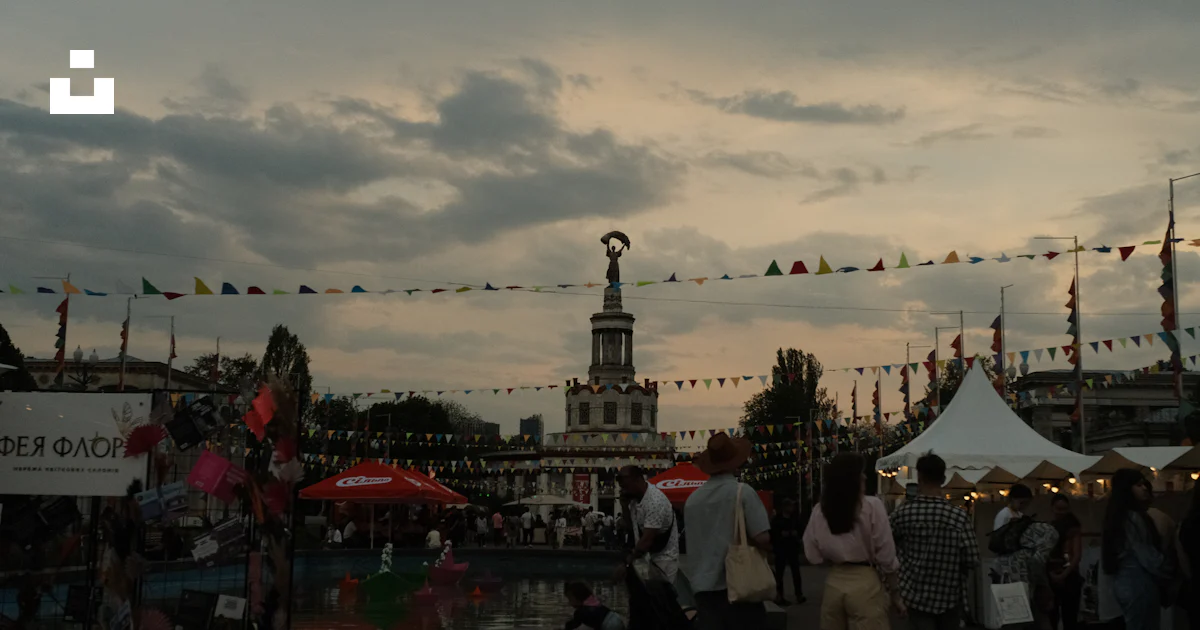 A fair or festival is happening outdoors at dusk. photo – Free ...