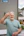Man gives peace sign, smiling brightly.