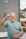 Man gives peace sign, smiling brightly.