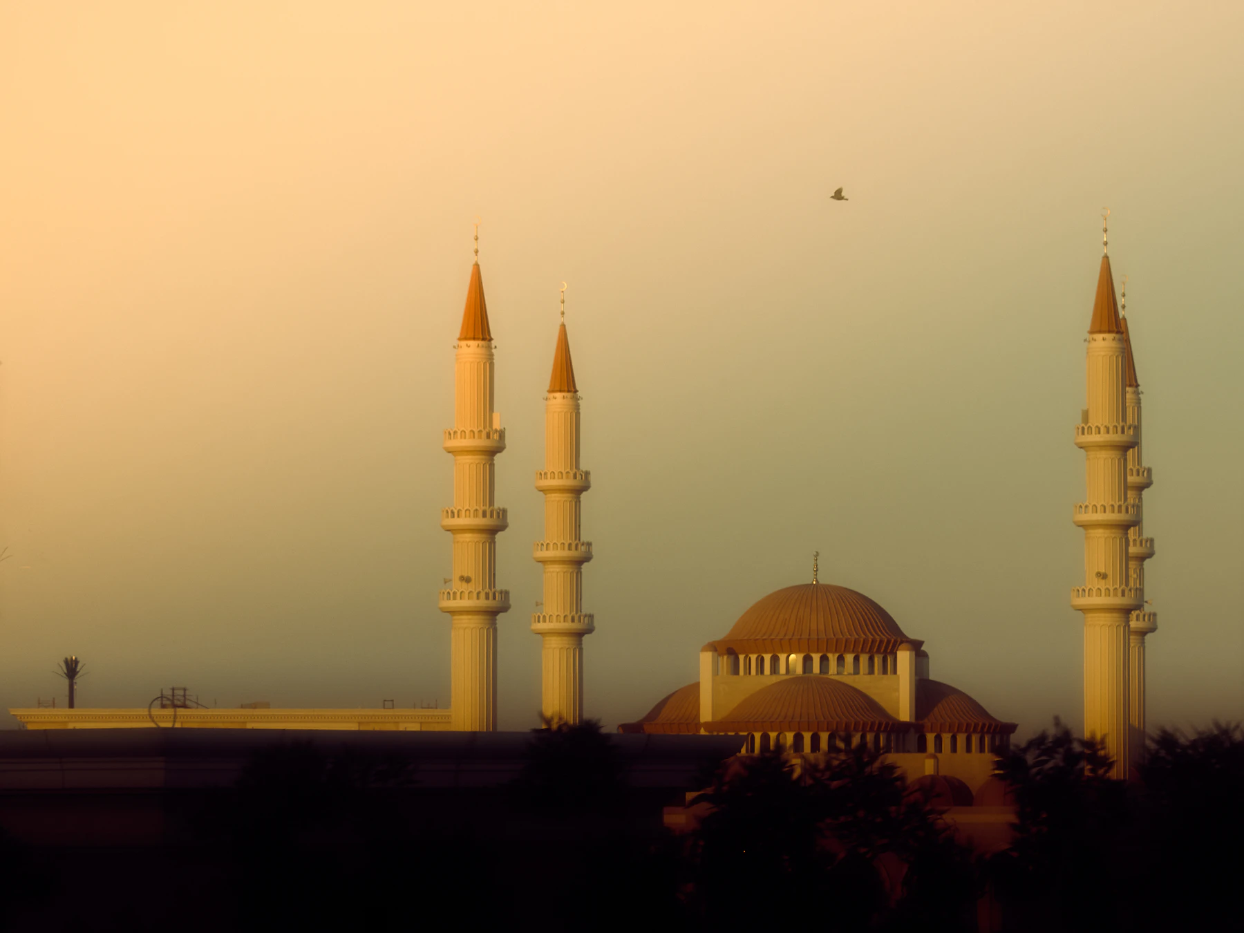 Mosque silhouetted against a sunset sky in Cairo