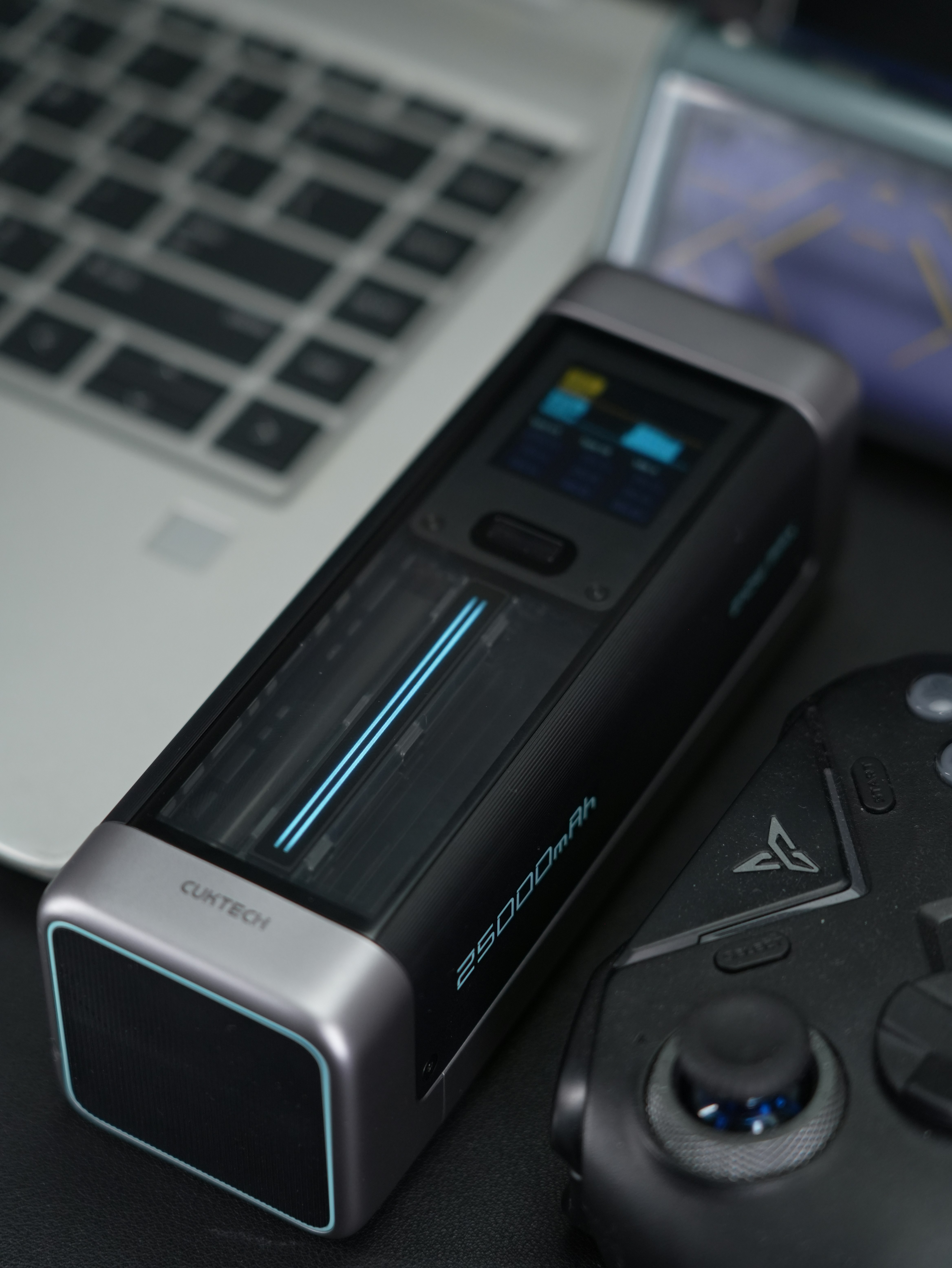 A tech device with display and controller.