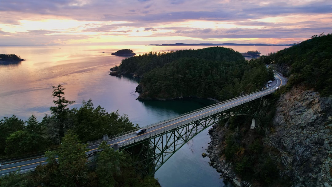 A bridge spans over the water at sunset.