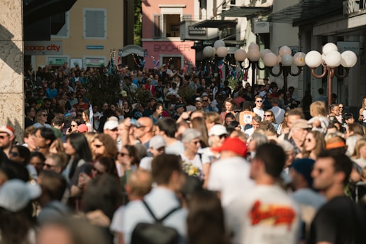 A huge crowd of people gathers outdoors.